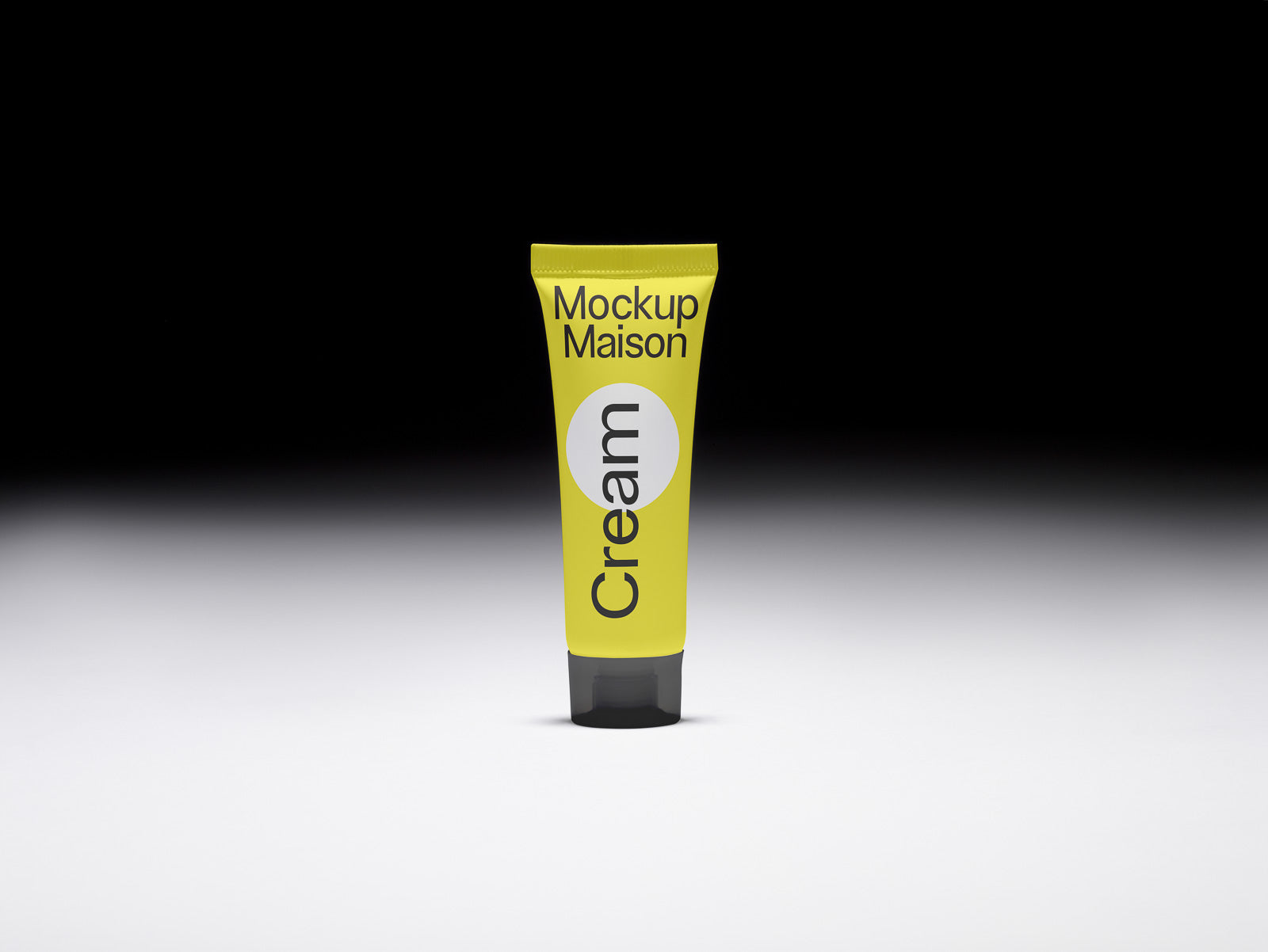 PSD mockup of a yellow cream tube labeled "Mockup Maison" with a minimalist design, centered against a gradient black and white background.