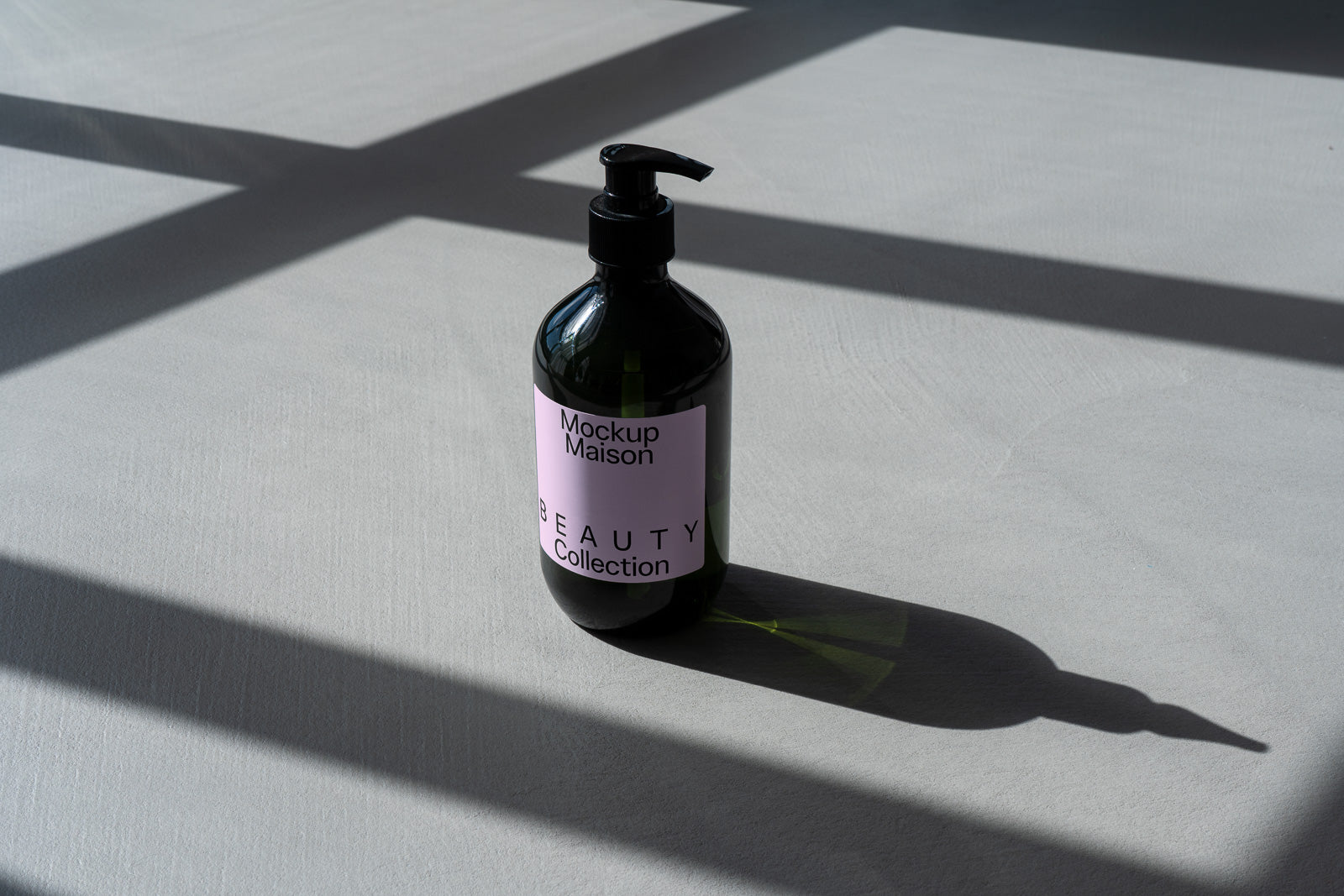 PSD mockup of a dark glass pump bottle labeled "Mockup Maison Beauty Collection" casting a shadow on a light surface with intersecting lines.