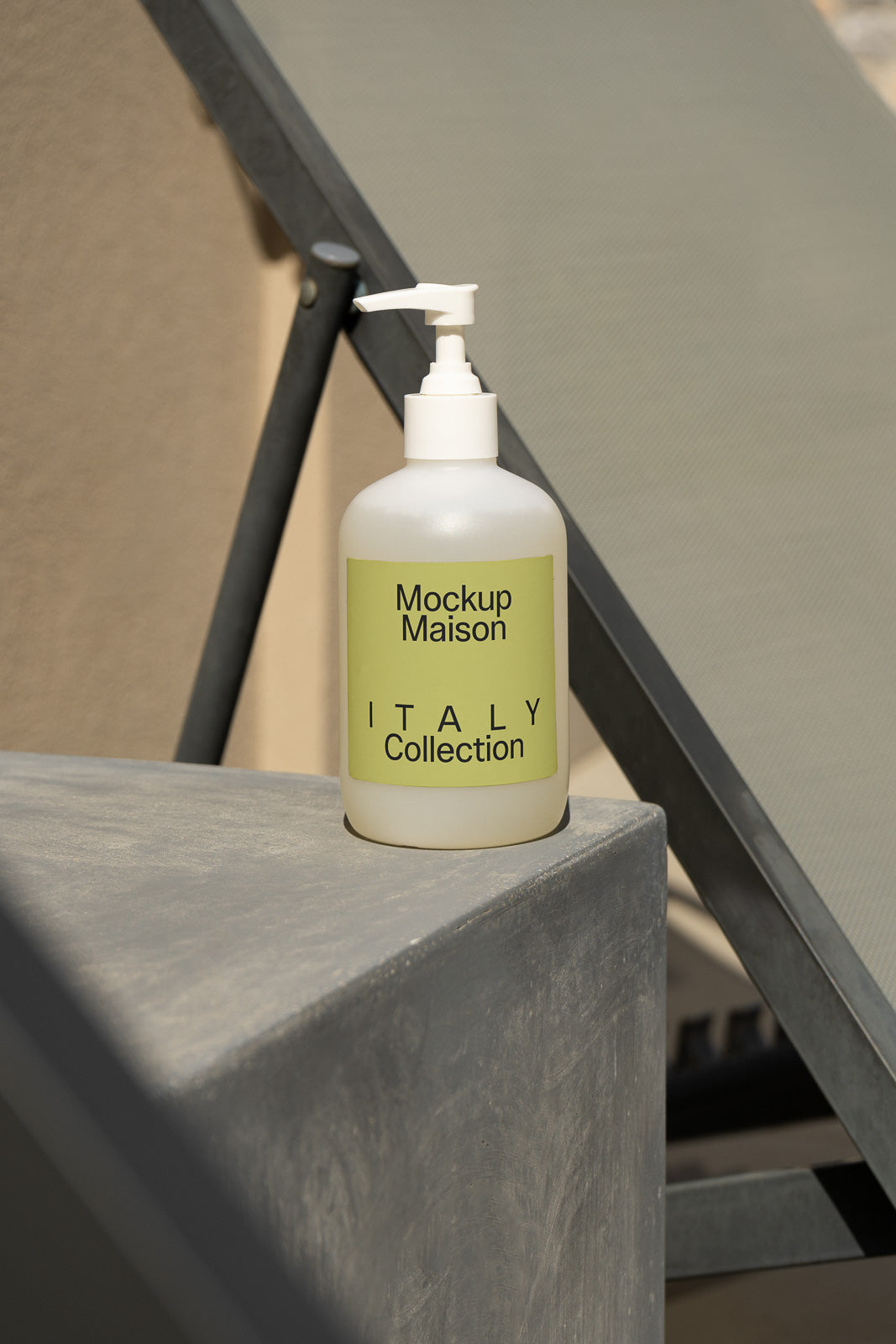 PSD mockup of a white pump bottle labeled "Mockup Maison Italy Collection" positioned outdoors on a concrete surface.