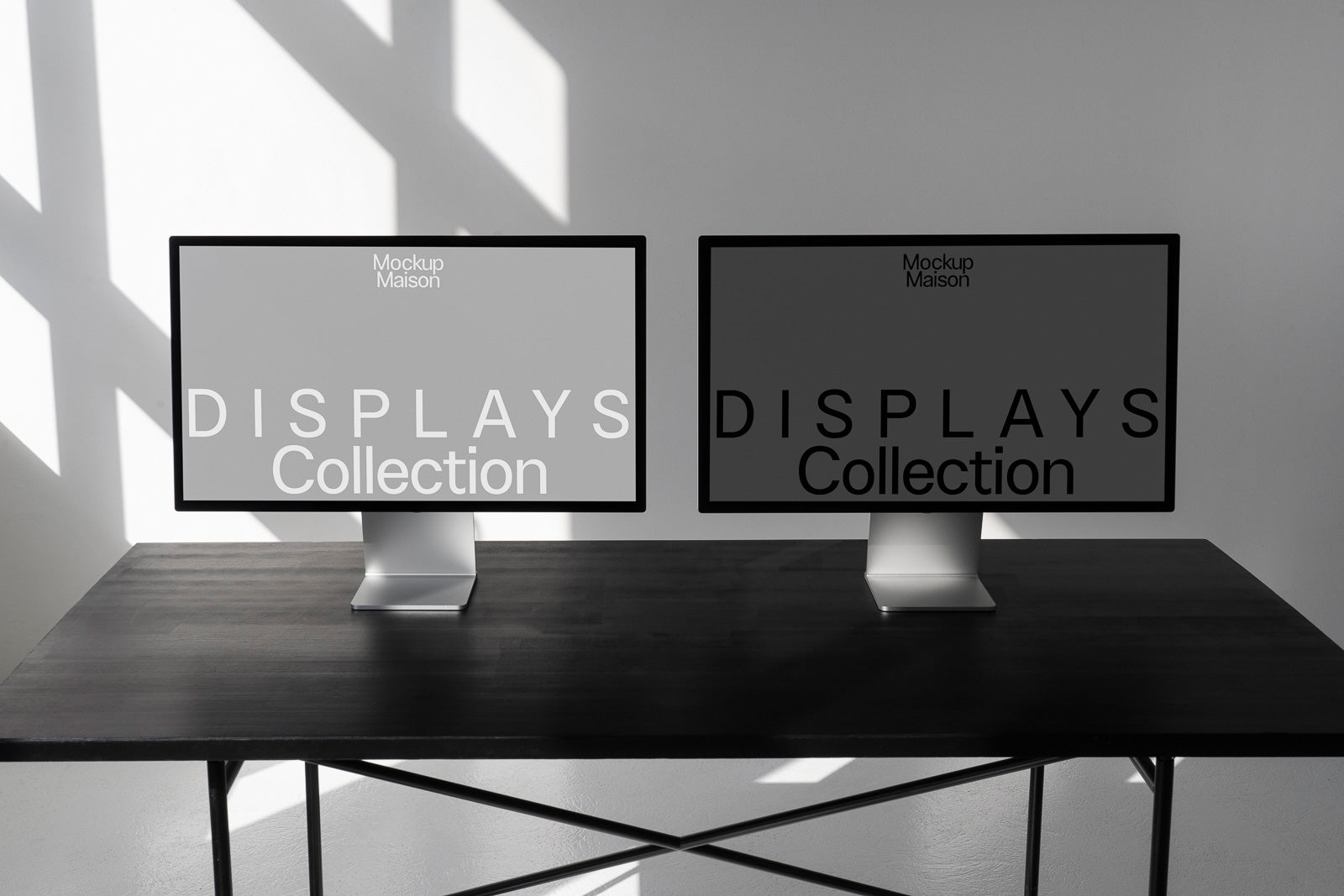 PSD mockup of two computer monitors displaying the text "DISPLAYS Collection" on a sleek, dark table against a shadowed wall background.