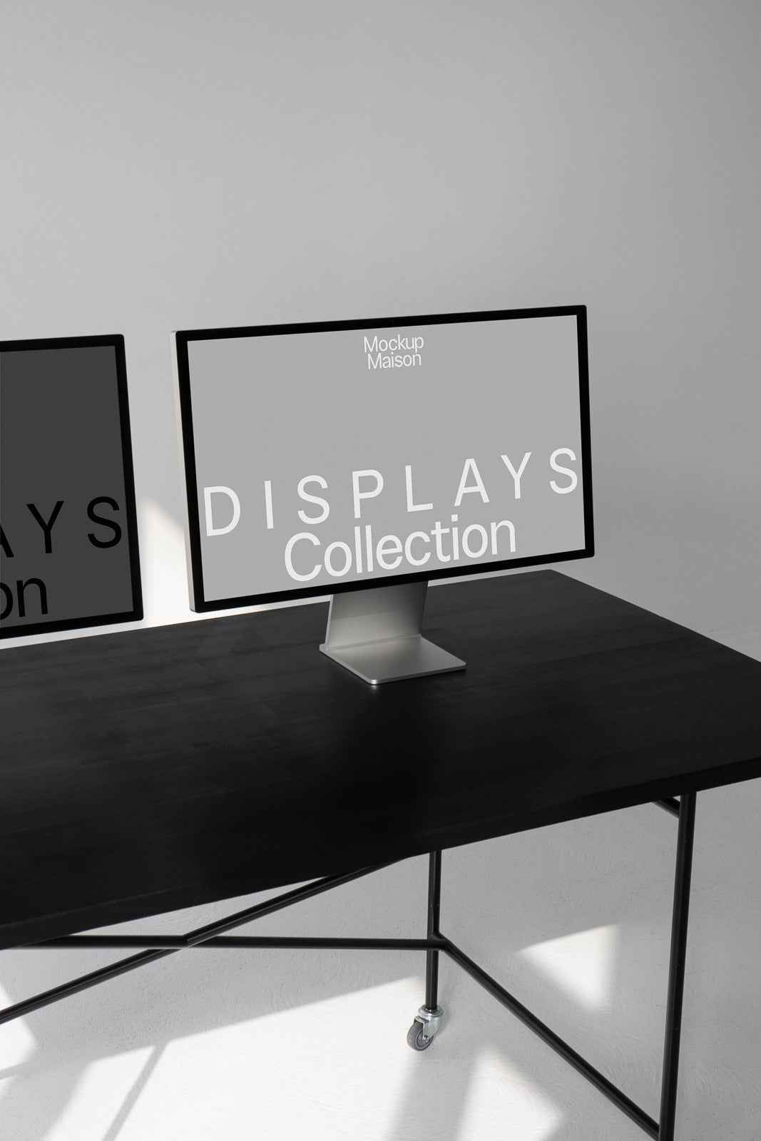 PSD mockup of a computer monitor on a black table, with "Displays Collection" text, set against a minimalist room with metal legs and white walls.