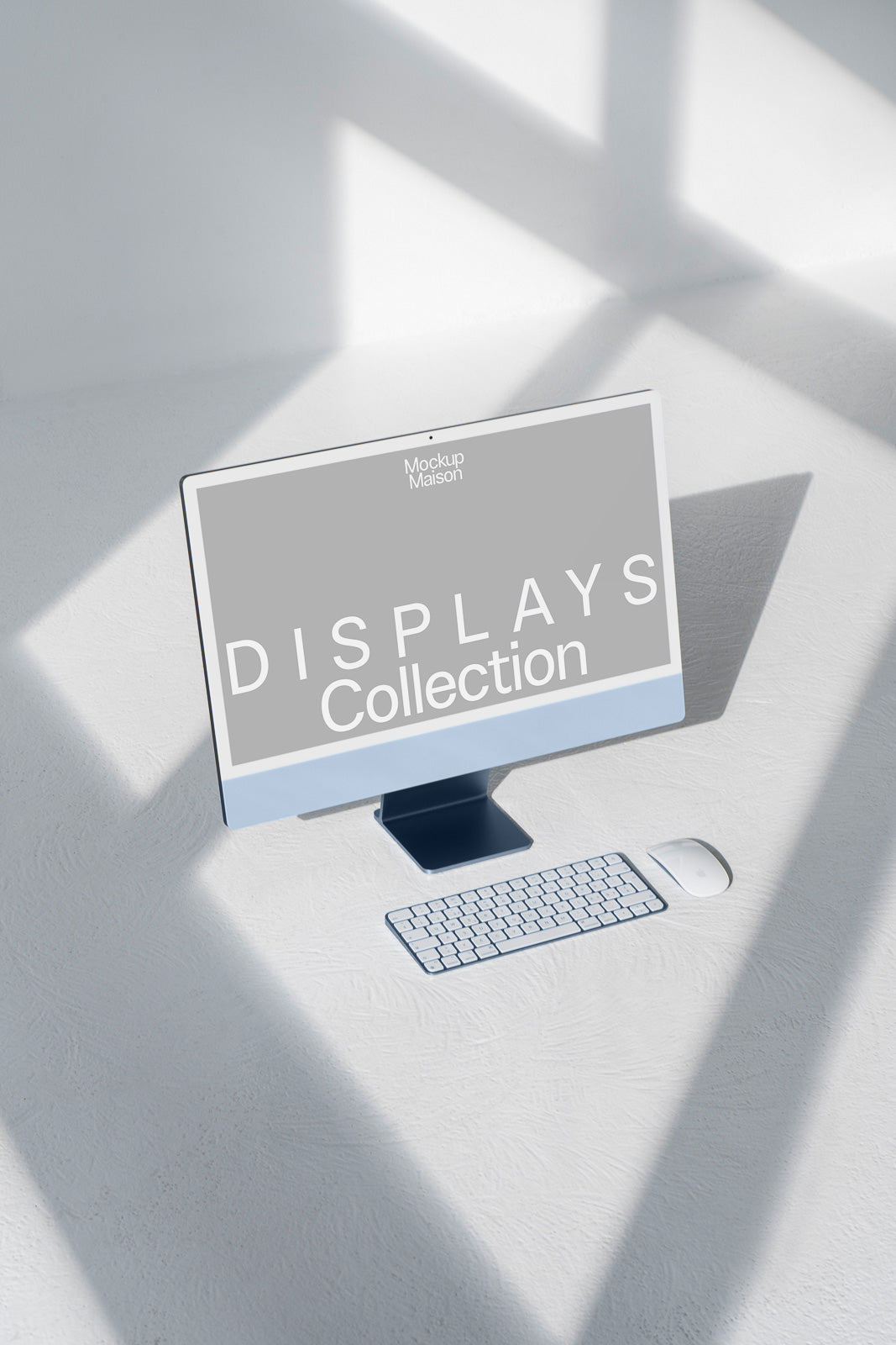 PSD mockup of a sleek desktop computer with a keyboard and mouse on a light surface, displaying "Mockup Maison" and "Displays Collection" on the screen.