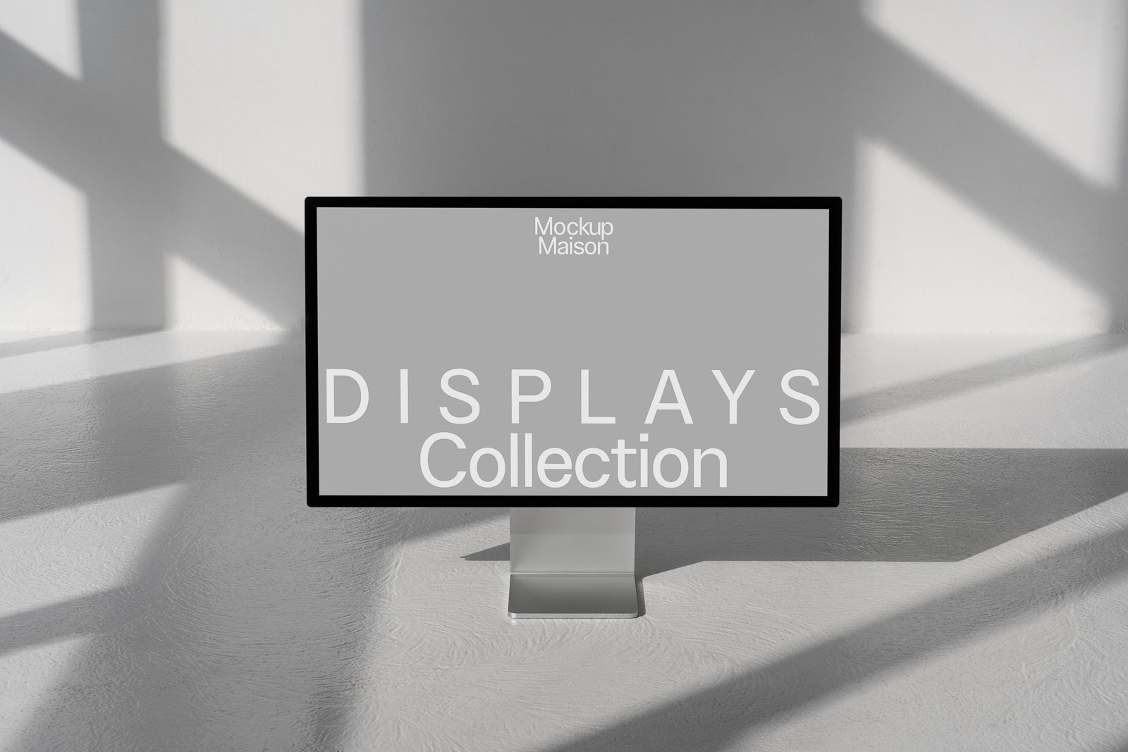 PSD mockup of a sleek computer monitor displaying the text "Mockup Maison DISPLAYS Collection" with a minimalist, sunlit backdrop.