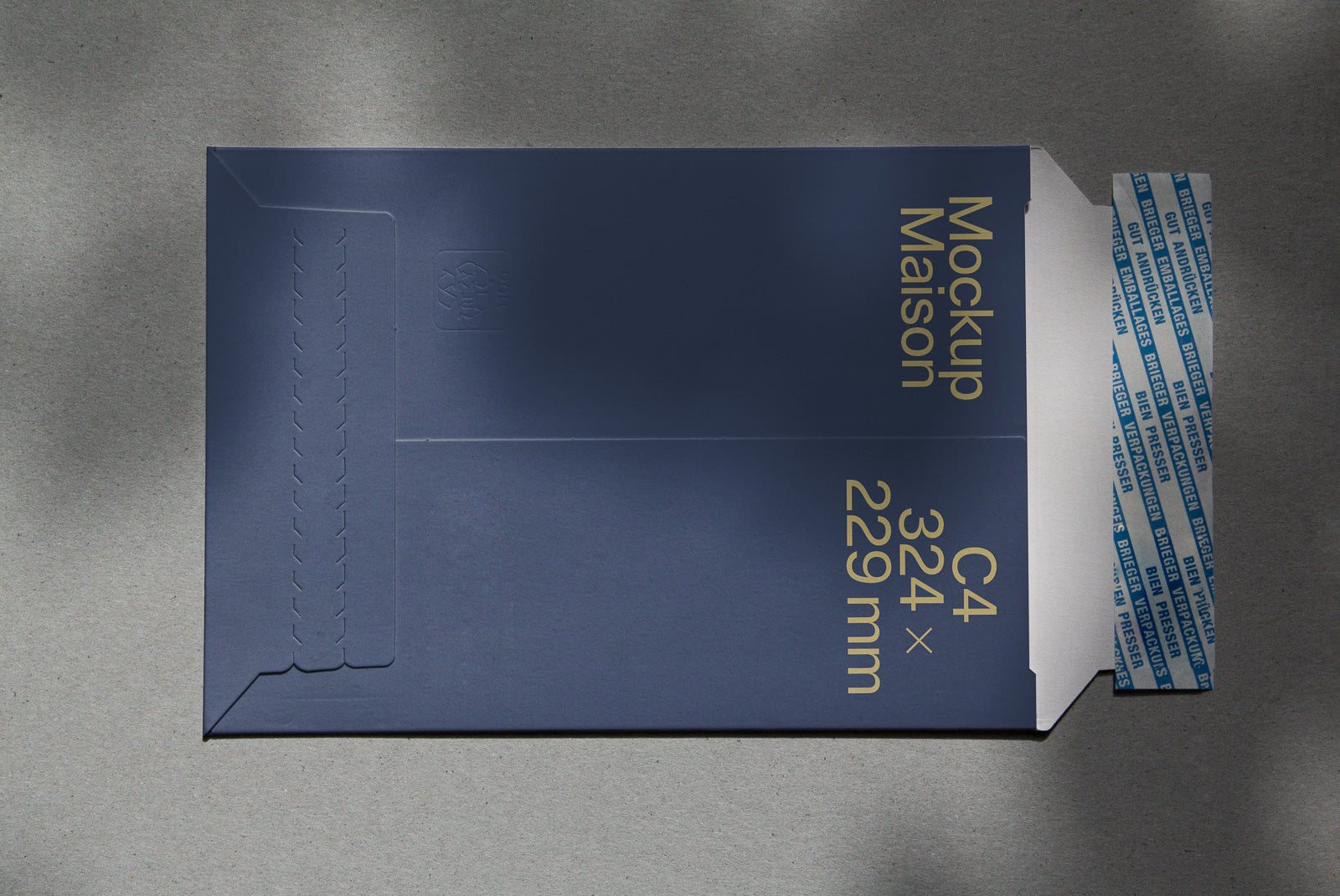 PSD mockup of a blue C4-sized envelope with a 324x229 mm label, featuring an adhesive strip on a textured background.