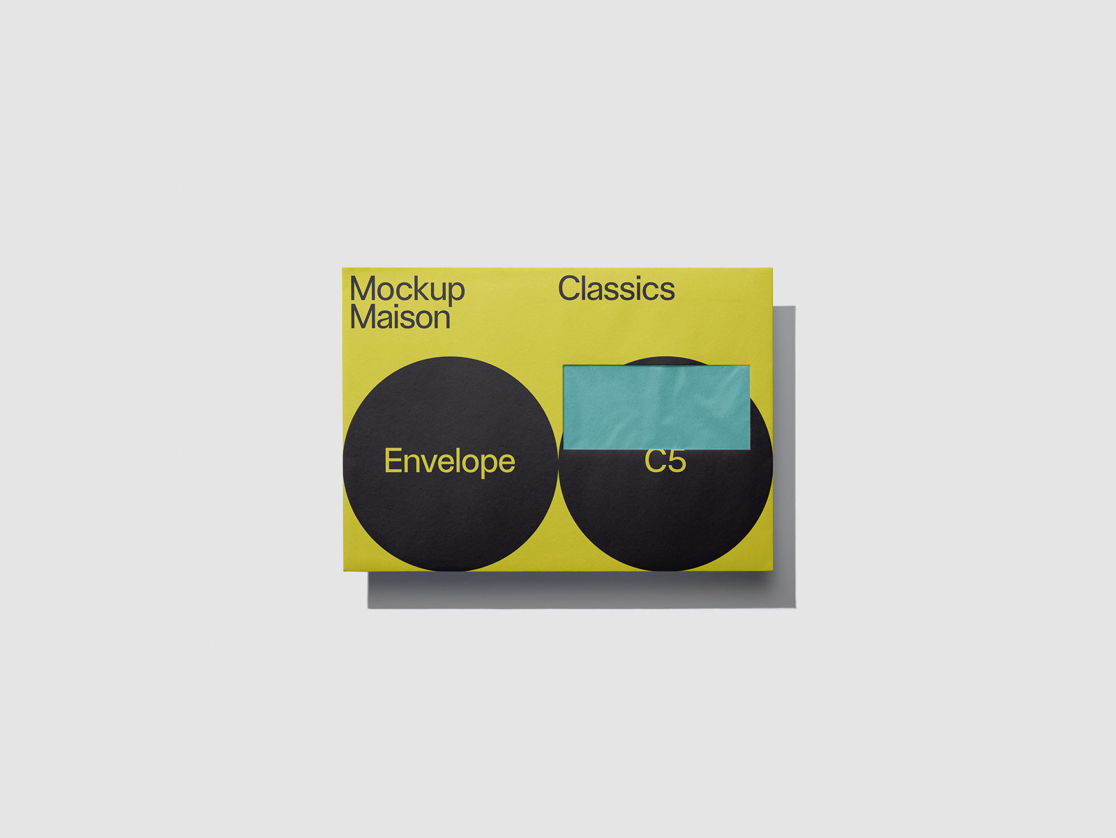 PSD mockup of a yellow envelope with black circular designs labeled "Envelope" and "C5," featuring text "Mockup Maison Classics" at the top.