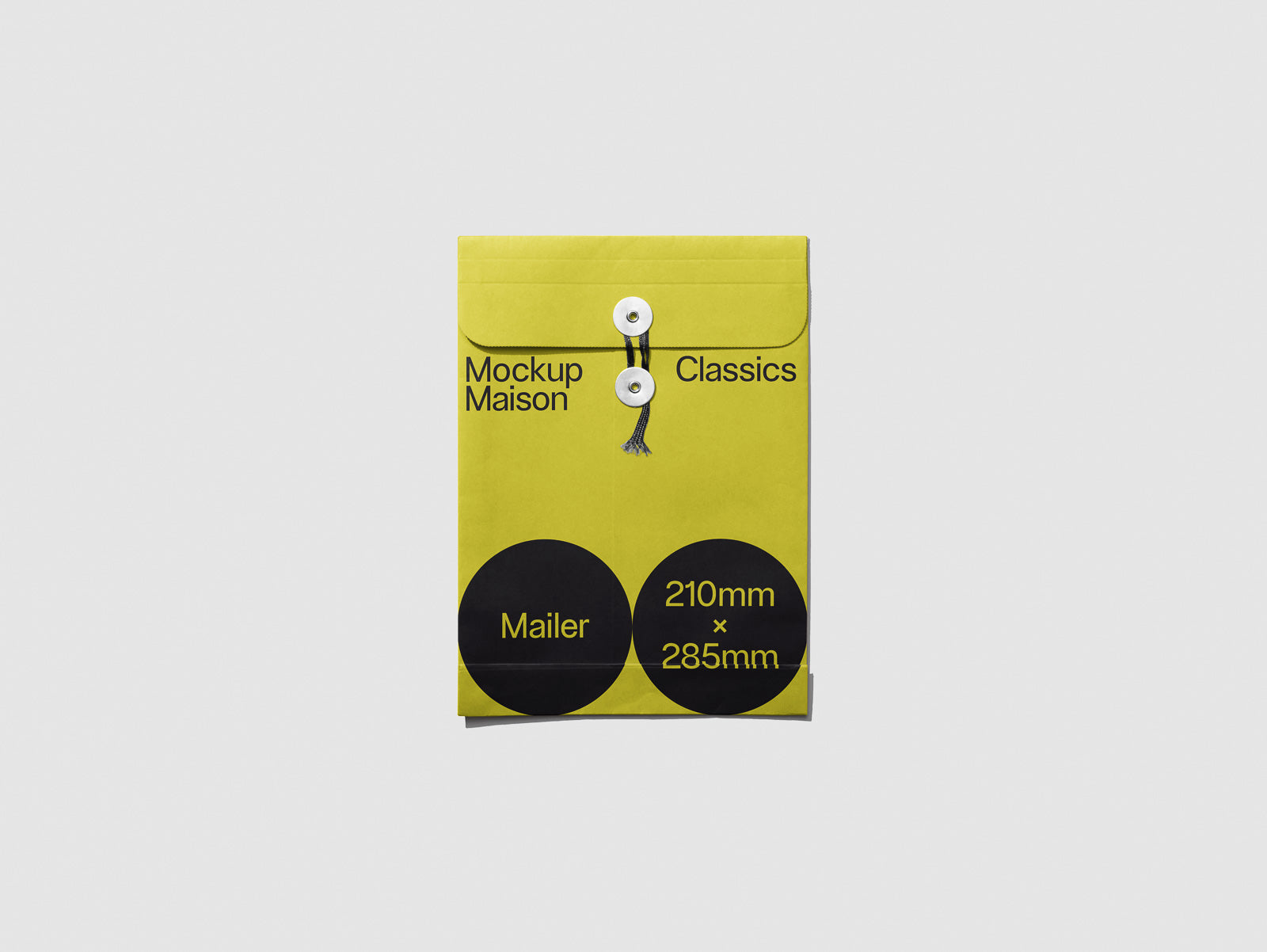 PSD mockup of a yellow envelope with "Mockup Maison Classics" text, featuring circular labels displaying "Mailer" and dimension "210mm x 285mm".