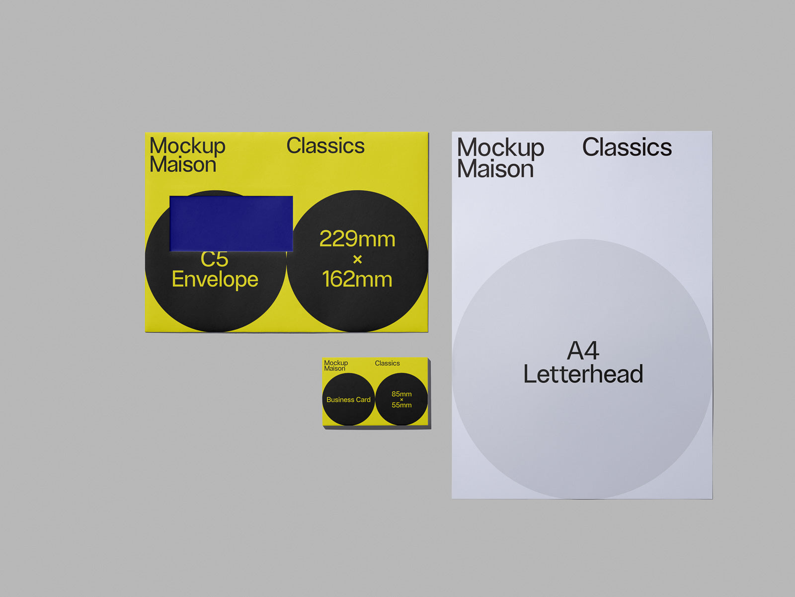 PSD mockup of stationery set including a C5 envelope, A4 letterhead, and business card with bold text and geometric design elements.