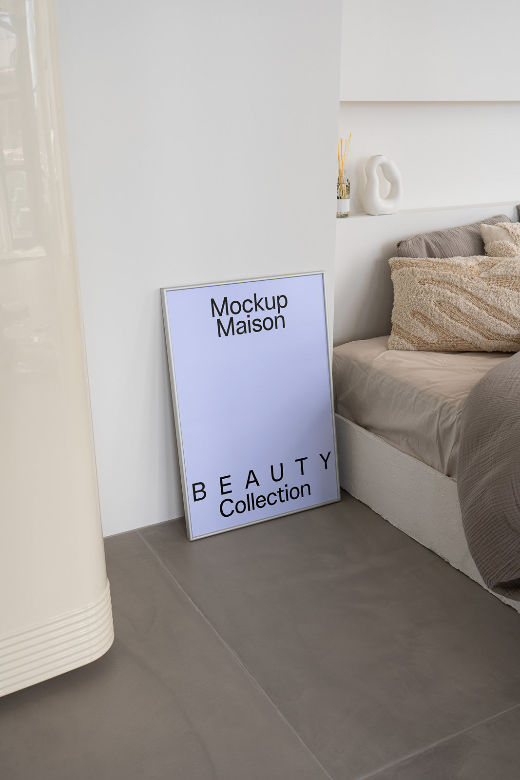 PSD mockup of a framed poster leaning against a wall in a modern bedroom setting, with text "Mockup Maison" and "Beauty Collection" displayed.