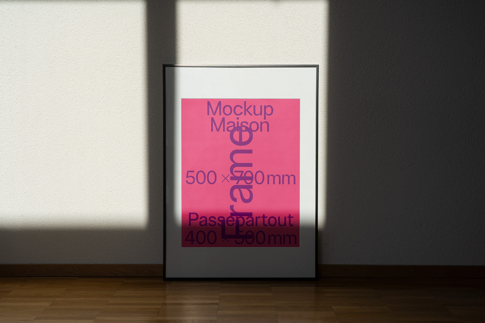 PSD mockup of a framed poster leaning against a wall with a pink background and text in various sizes displaying dimensions.