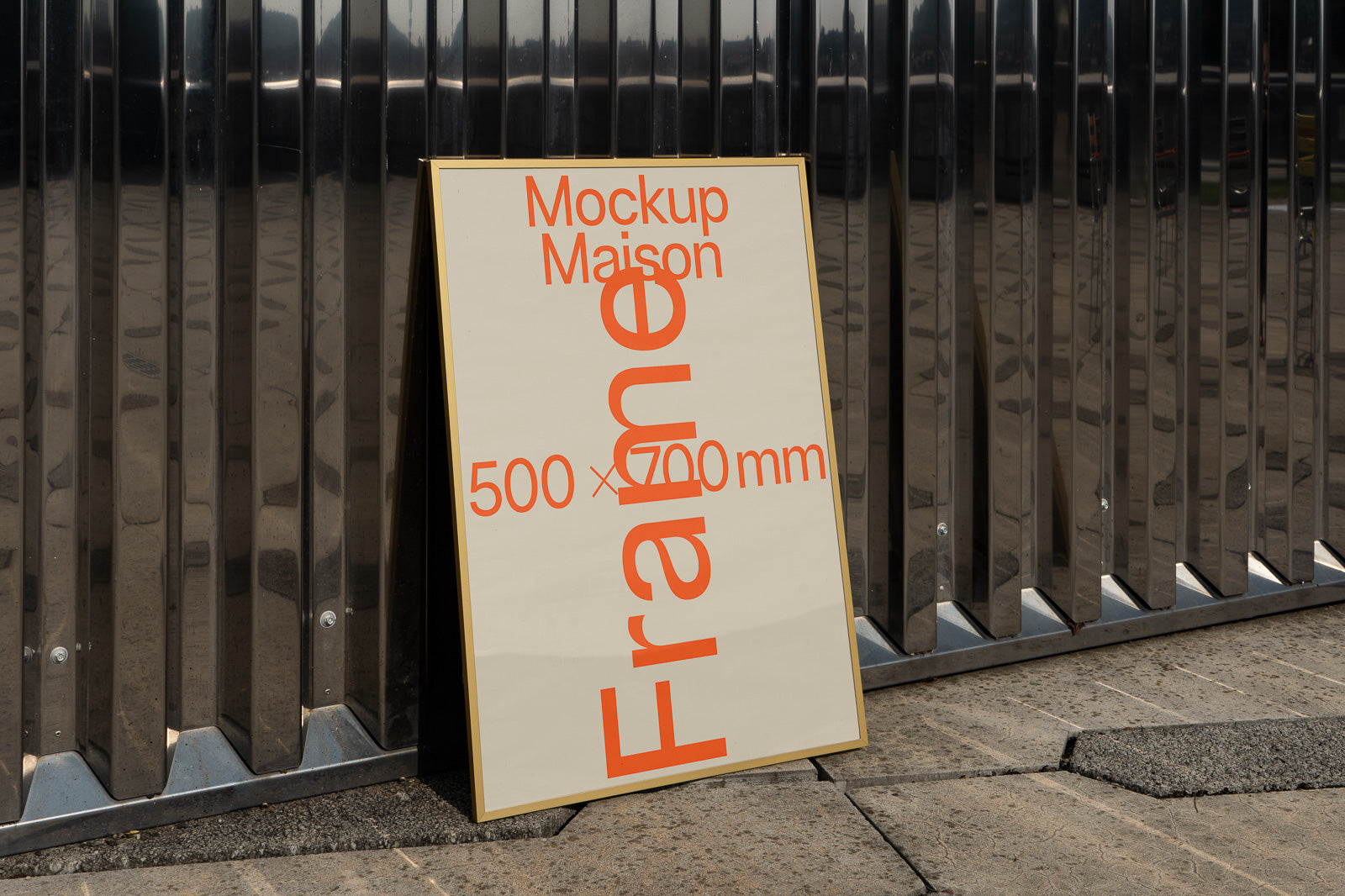 PSD mockup of a vertical frame with "Mockup Maison" and "500 x 700 mm" text, leaning against a metal wall.