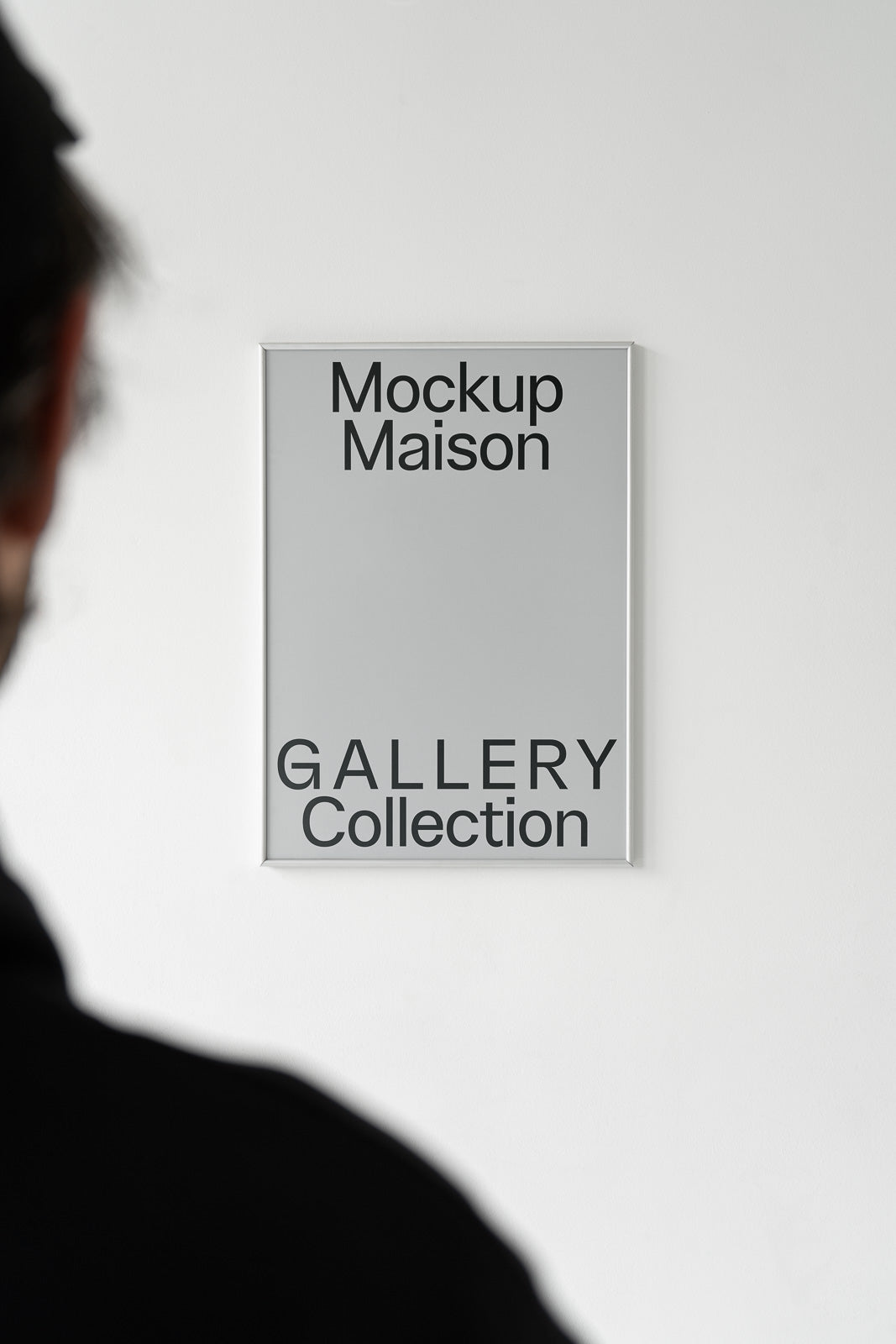 PSD mockup of a person viewing a poster on a wall, featuring the text "Mockup Maison Gallery Collection".