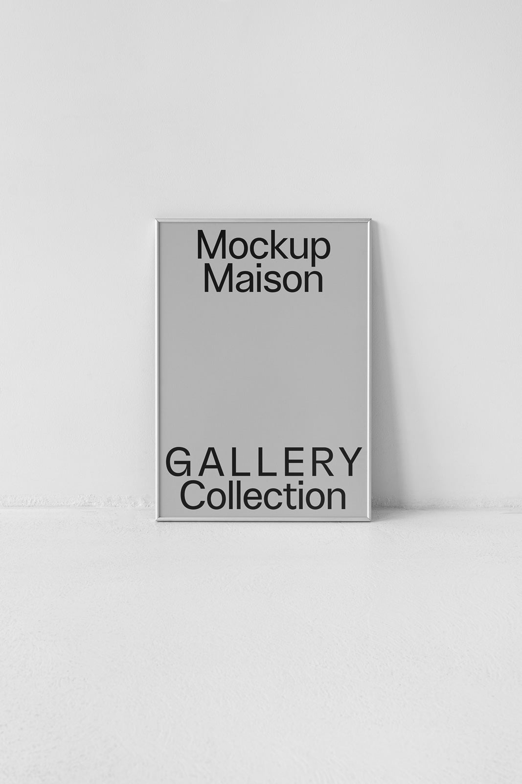 PSD mockup of a framed poster titled "Mockup Maison Gallery Collection" leaning against a white wall on a smooth floor.