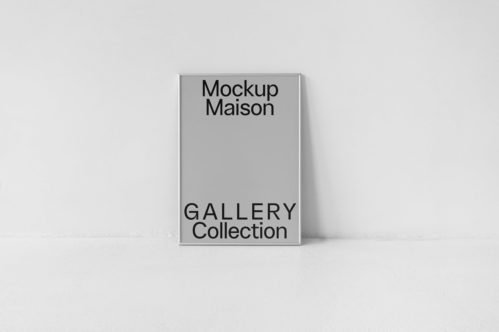 PSD mockup of a framed poster leaning against a minimalist white wall with text "Mockup Maison" and "Gallery Collection" in bold black letters.