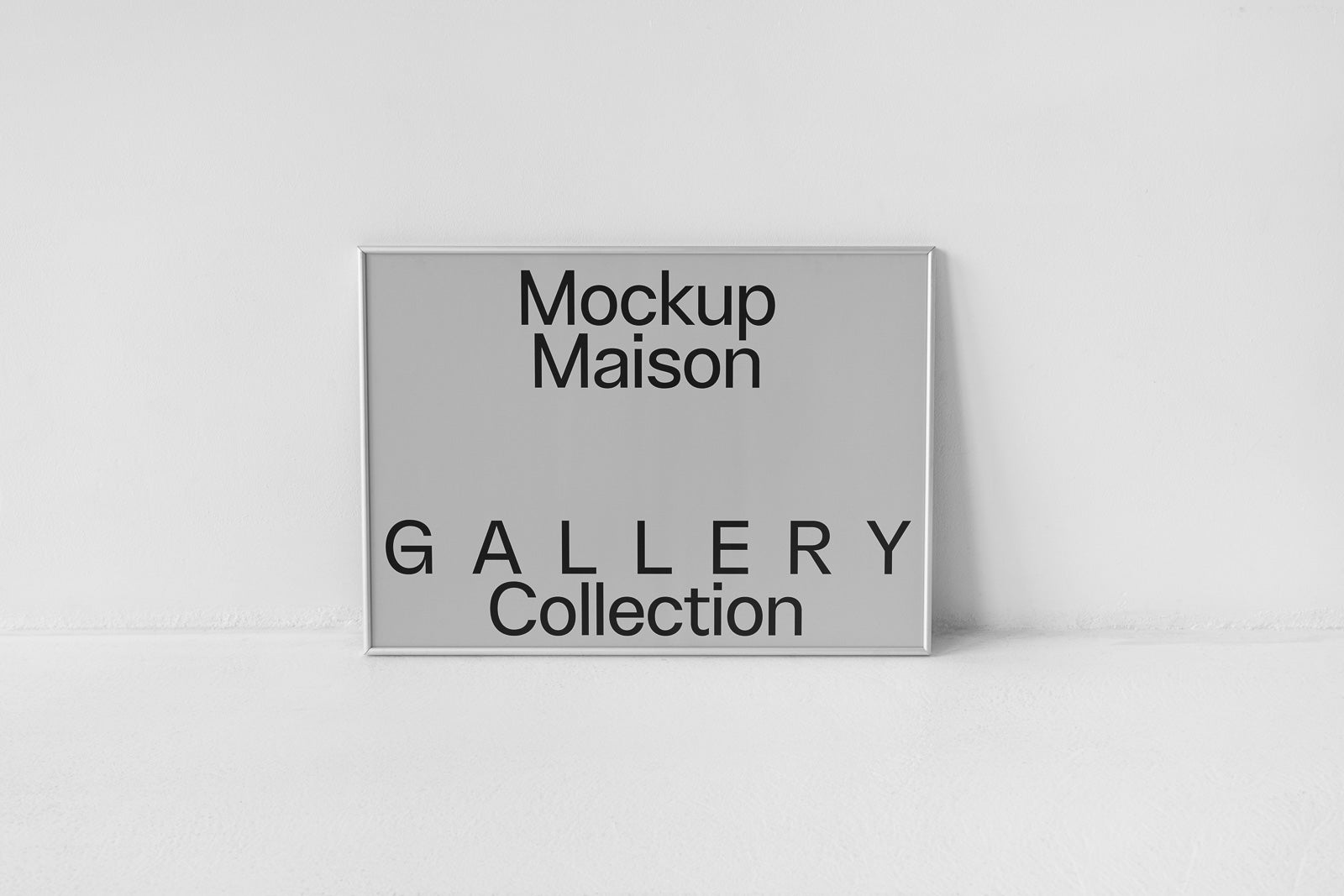 PSD mockup of a silver-framed poster on a white floor and wall, displaying "Mockup Maison" and "Gallery Collection" in bold black text.