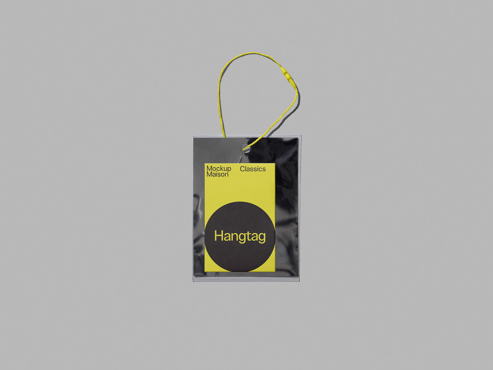PSD mockup of a hangtag with a yellow and black design, featuring text "Mockup Maison Classics" and "Hangtag," attached with a string.