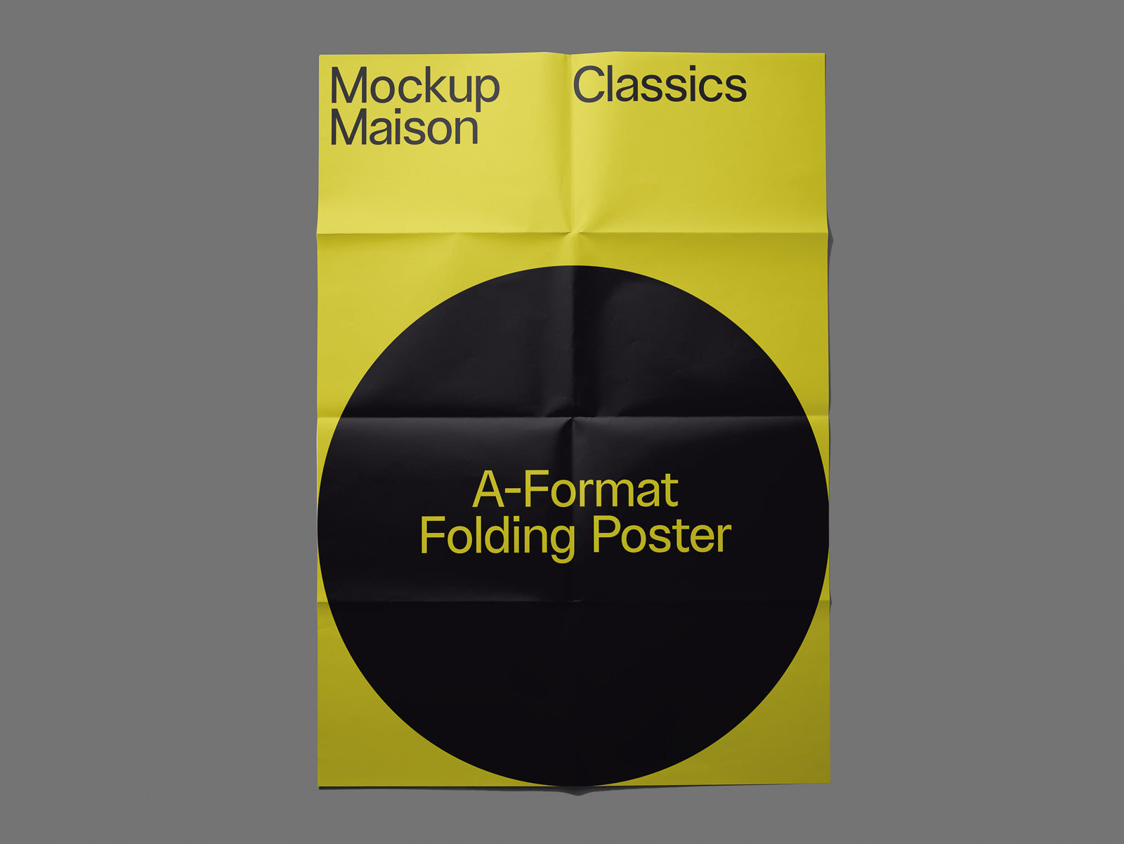 PSD mockup of a yellow A-format folding poster, featuring bold black text and a large black circle with creases visible, set against a gray background.