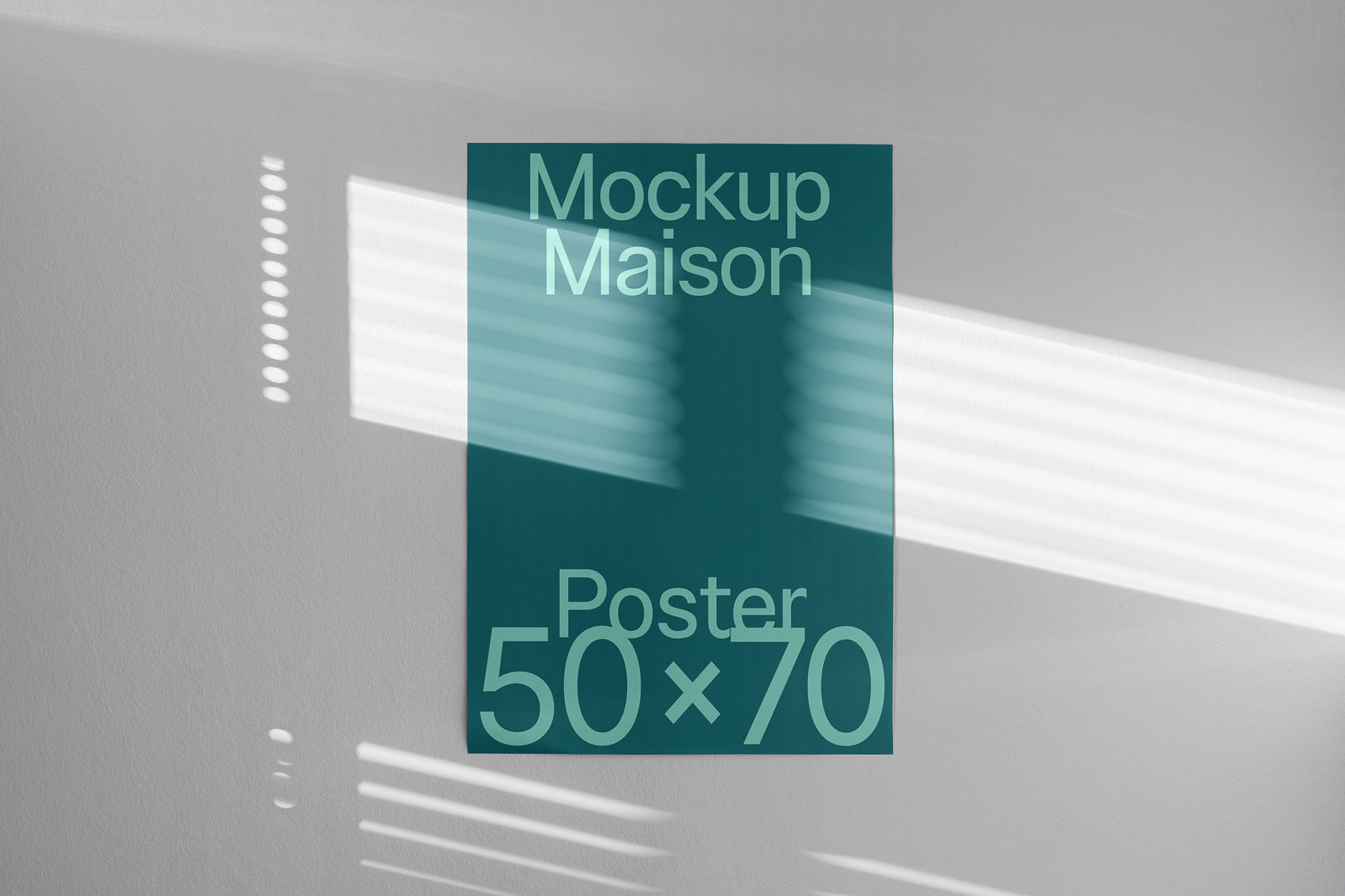 PSD mockup of a 50x70 poster with "Mockup Maison" text on a wall, featuring natural light and shadow patterns casting across it.