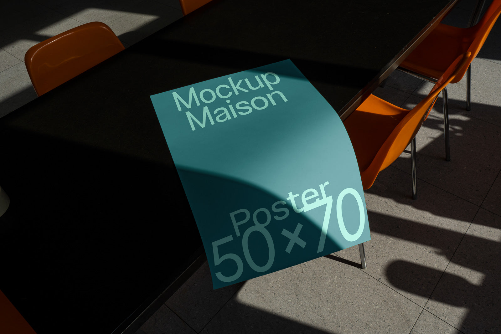 PSD mockup of a teal poster with "Mockup Maison" and "Poster 50x70" text, draped over a black table, surrounded by orange chairs.