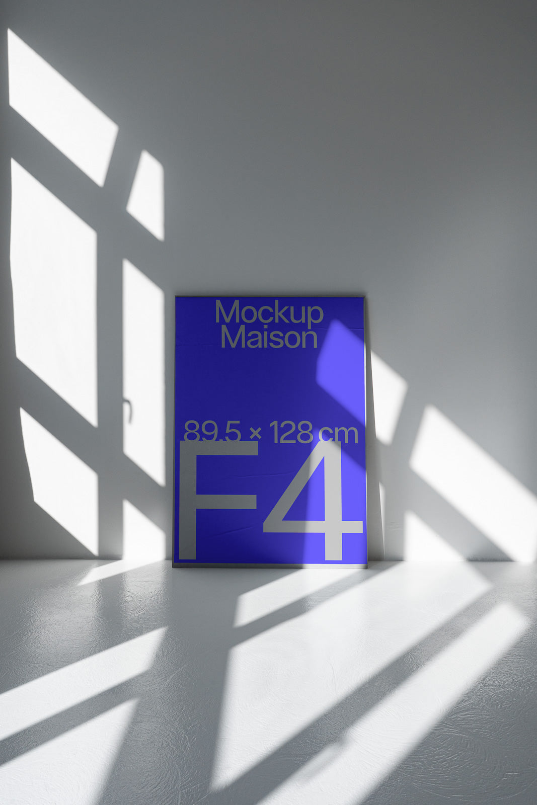PSD mockup of a large, vibrant blue poster labeled "Mockup Maison 89.5 x 128 cm F4" leaning against a wall, with sunlit shadows creating dramatic angles on the floor.