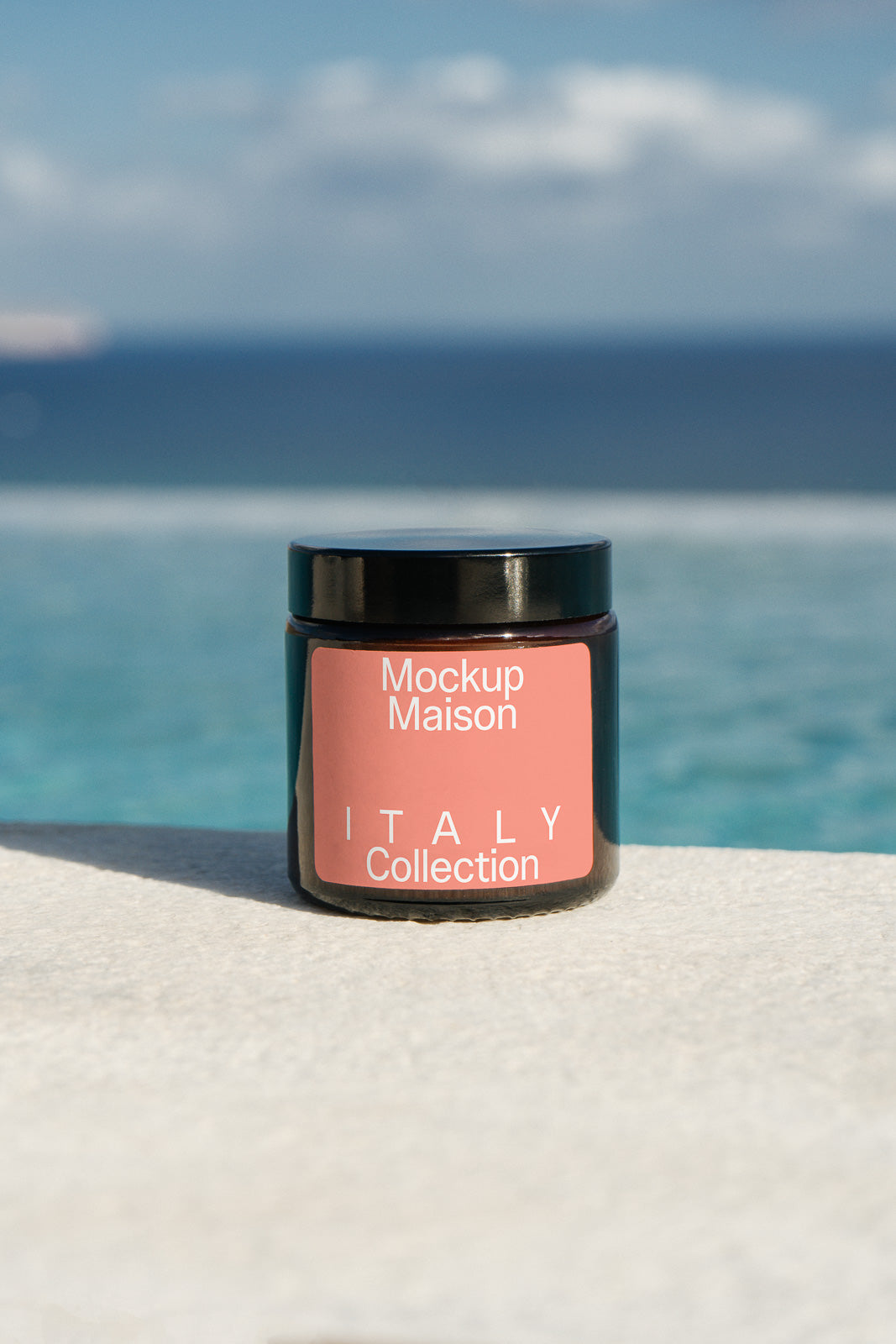PSD mockup of a jar labeled "Mockup Maison Italy Collection" set against an ocean backdrop, highlighting product design.