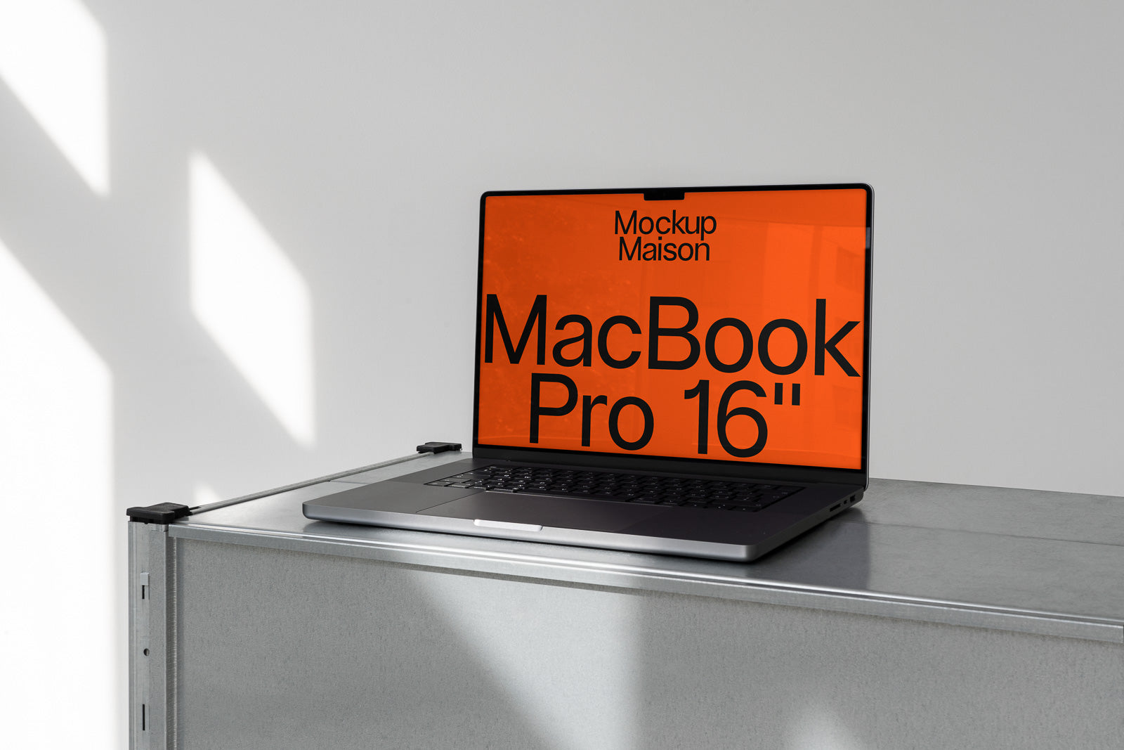 PSD mockup of a MacBook Pro 16" with an orange screen placed on a metal surface, capturing a minimalist and modern aesthetic.