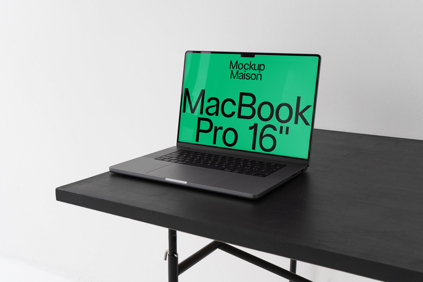 PSD mockup of a MacBook Pro 16-inch laptop on a black wooden table, displaying a vibrant green screen with text.