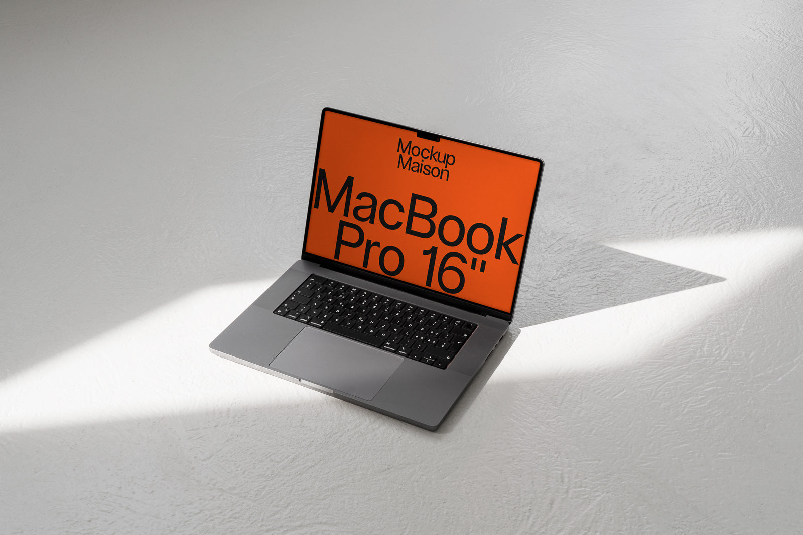 PSD mockup of an open MacBook Pro 16-inch on a light surface with an orange screen displaying text.