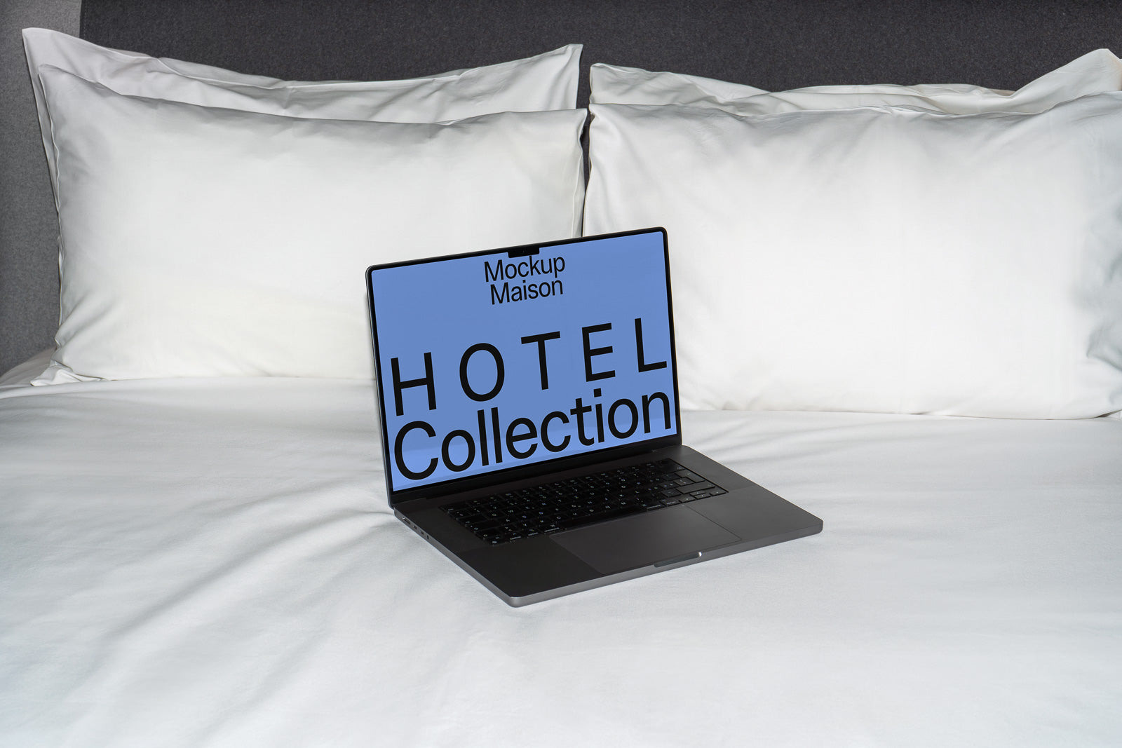 PSD mockup of a laptop on a neatly made bed with two white pillows, displaying "Hotel Collection" on the screen.