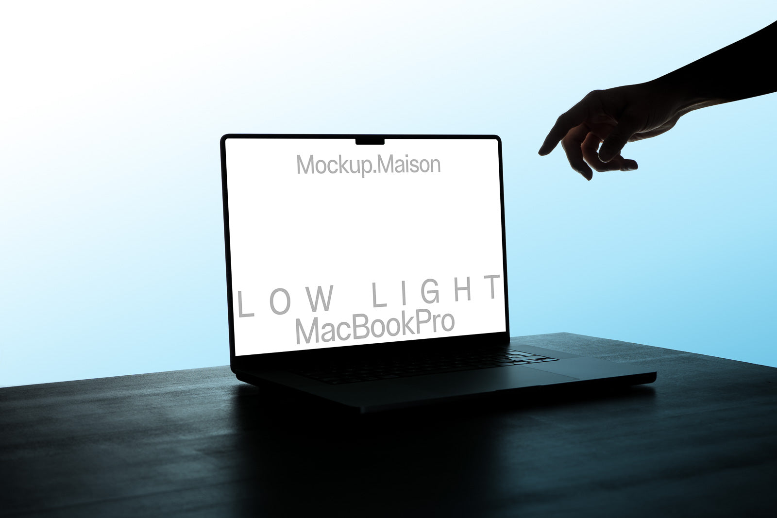 PSD mockup of a MacBook Pro with a hand reaching towards the screen. The display shows the text "Mockup.Maison" and "LOW LIGHT MacBookPro."
