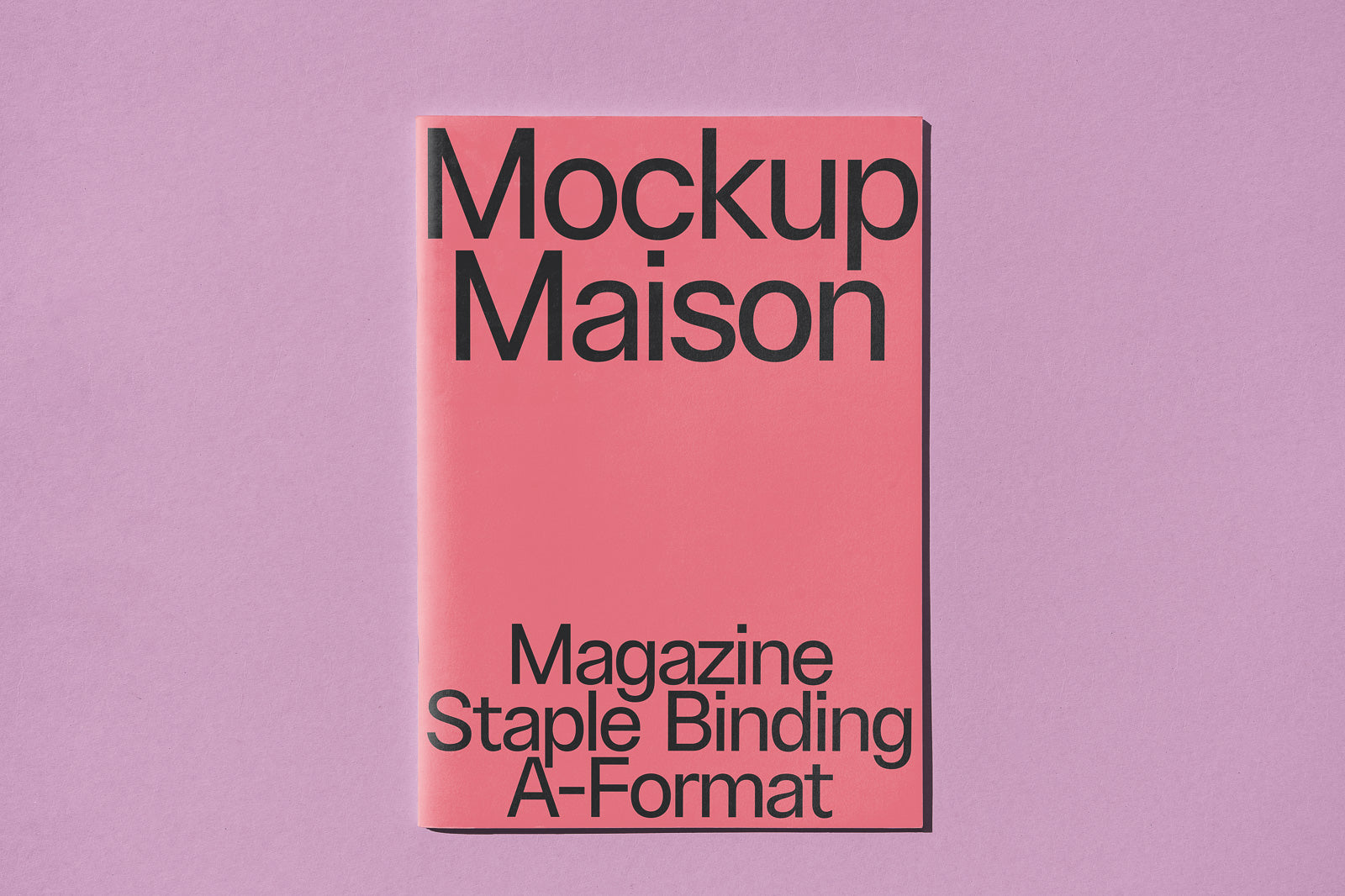 PSD mockup of a magazine with staple binding on a pink cover titled "Mockup Maison," set against a lavender background.