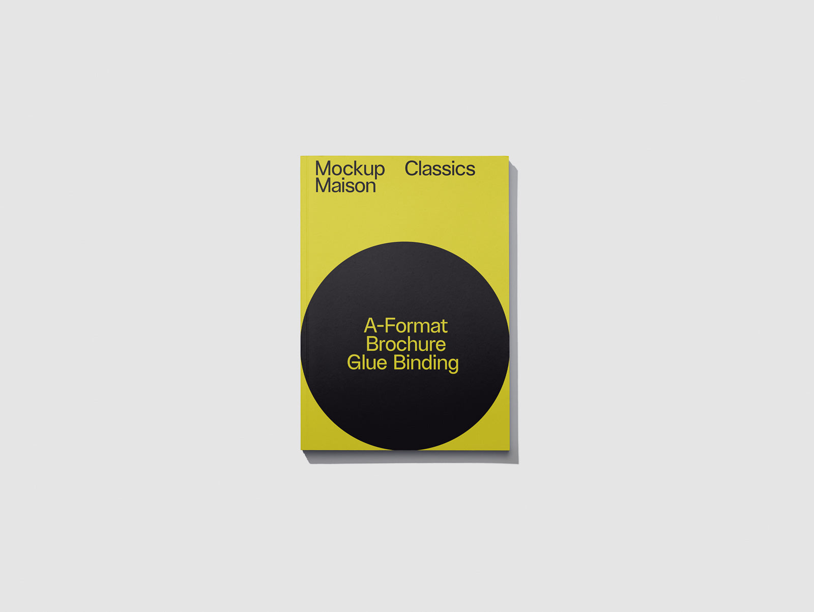 PSD mockup of a yellow booklet with a black circle, featuring text "A-Format Brochure Glue Binding" and "Mockup Maison Classics" at the top.