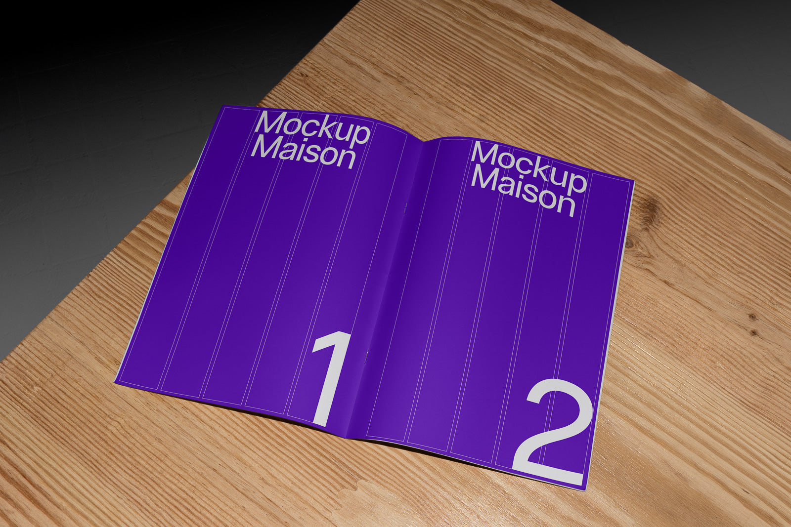 PSD mockup of an open magazine spread with a purple cover, labeled "Mockup Maison," displaying large numbers 1 and 2, resting on a wooden surface.