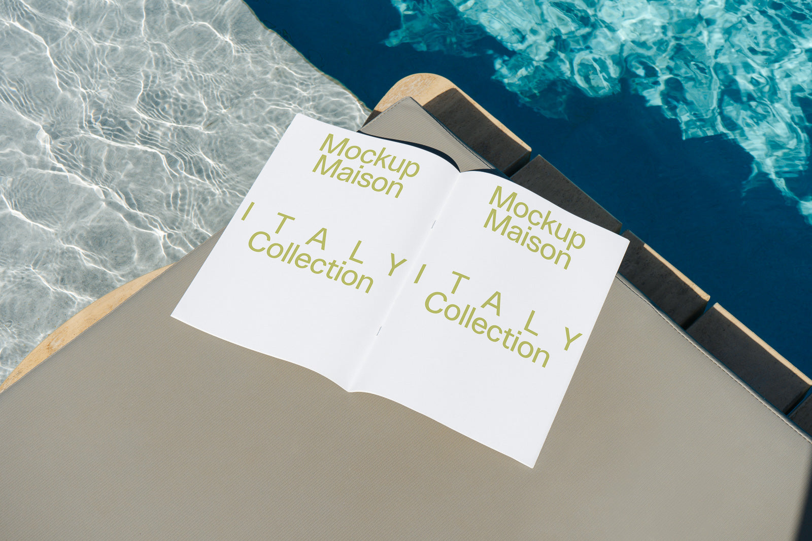 PSD mockup of a magazine open to a spread titled "Italy Collection" with stylized green text, placed on a lounge chair by a pool with shimmering water.