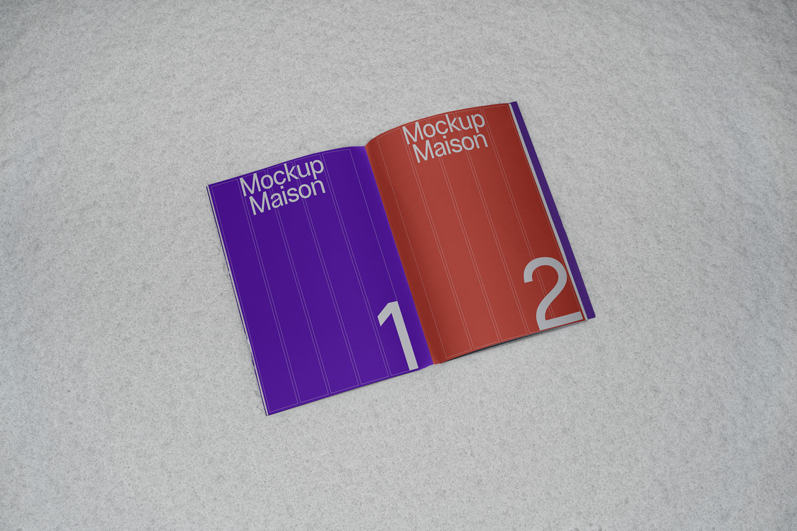 PSD mockup of an open booklet on a textured surface, with one page in purple and another in red, both labeled "Mockup Maison" with large numbers.