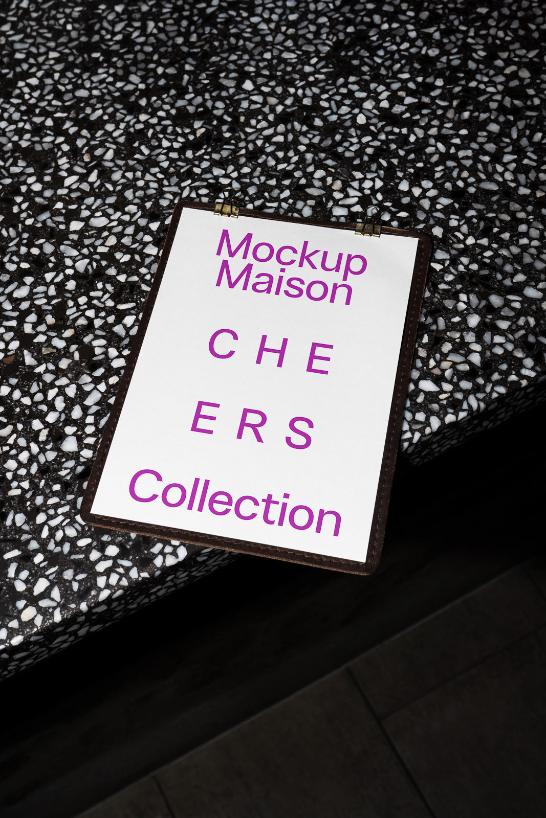 PSD mockup of a printed card titled "Mockup Maison CHEERS Collection" with bold purple text, placed on a terrazzo surface.