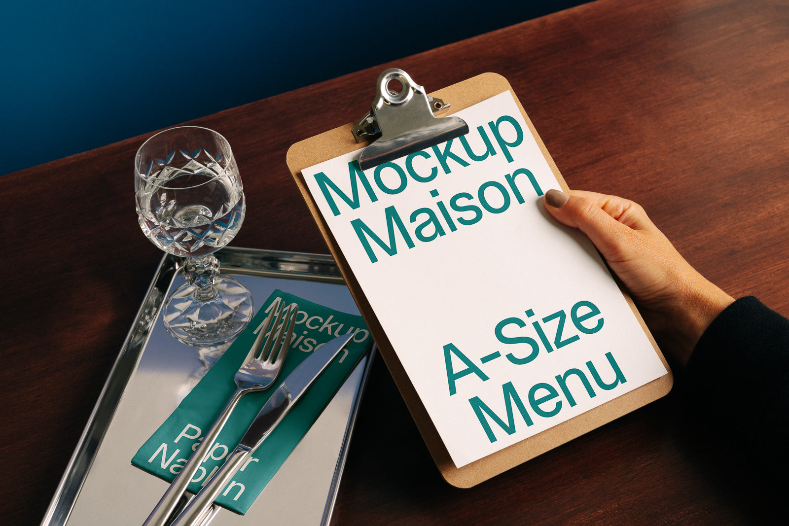 PSD mockup of a wooden clipboard holding an A-size menu, placed on a table with cutlery, a glass, and a reflection seen on a tray.