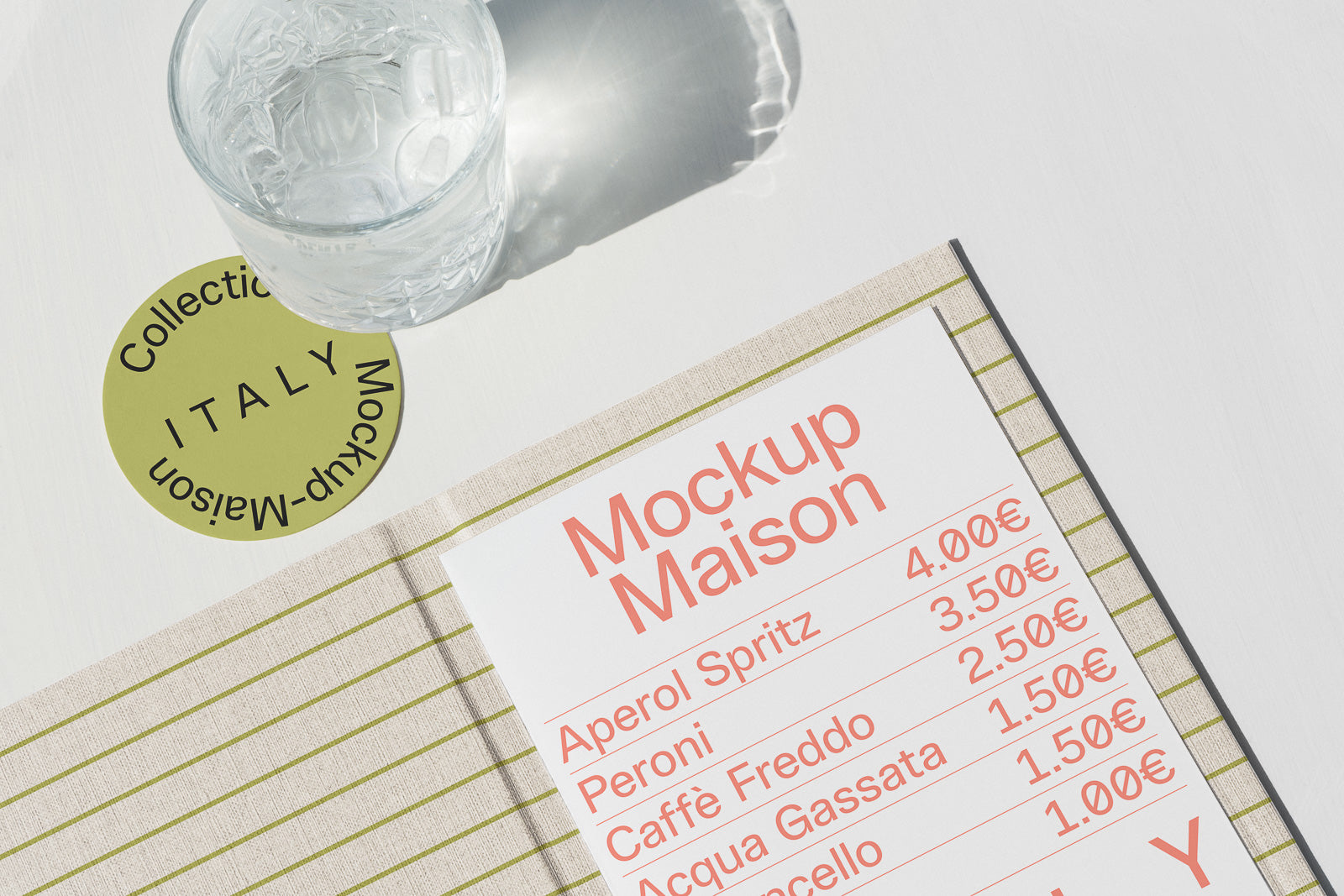 PSD mockup of a drink menu on a striped tablecloth next to a round green coaster labeled "Italy" under a glass of water.