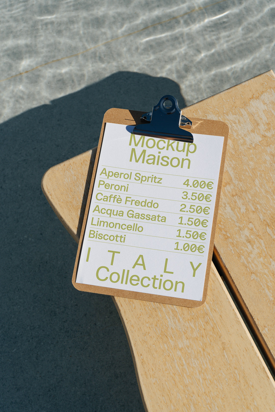 PSD mockup of a clipboard on a wooden surface with a menu listing items like Aperol Spritz and Peroni with prices in euros. Background includes a poolside setting.