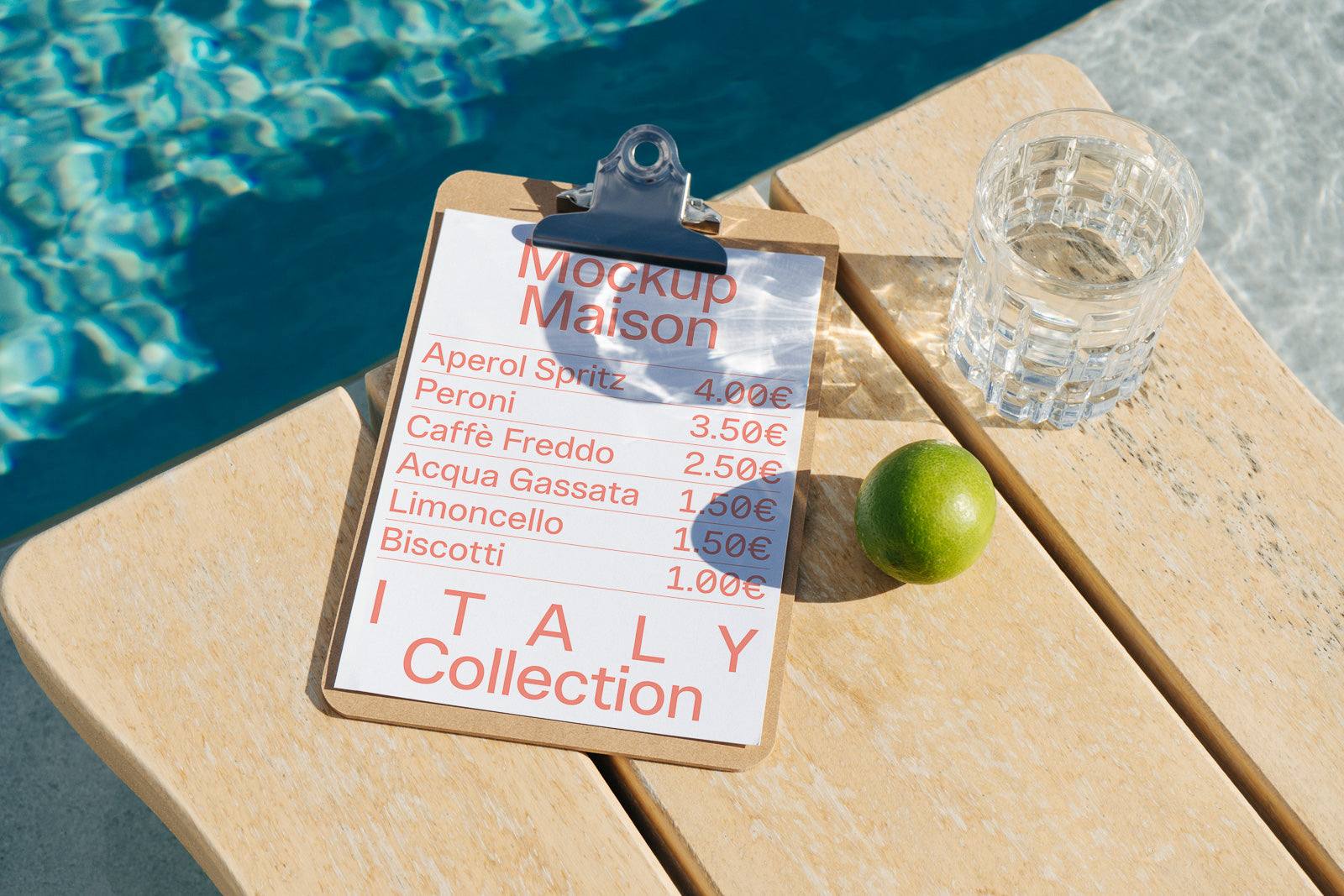 PSD mockup of a clipboard menu on a wooden table near a pool, featuring drinks and prices in euros, accompanied by a lime and a glass of water.