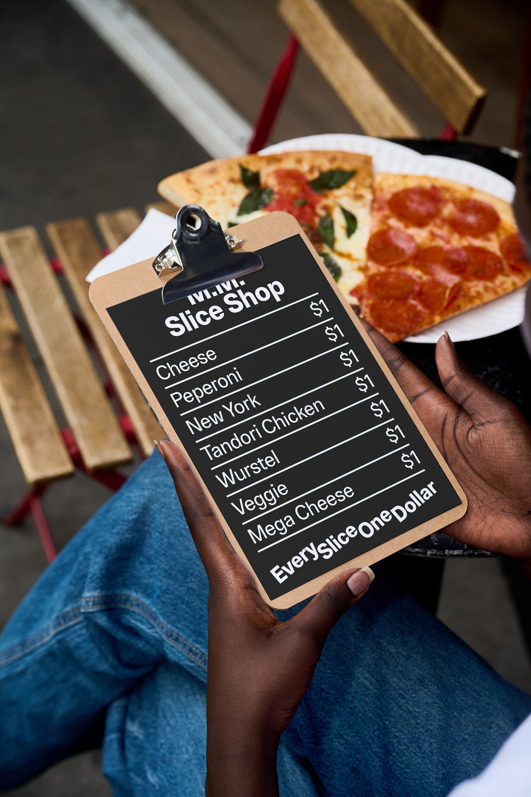 PSD mockup of a black clipboard with a pizza menu featuring various flavors like Cheese, Peperoni, and Mega Cheese, each priced at one dollar.
