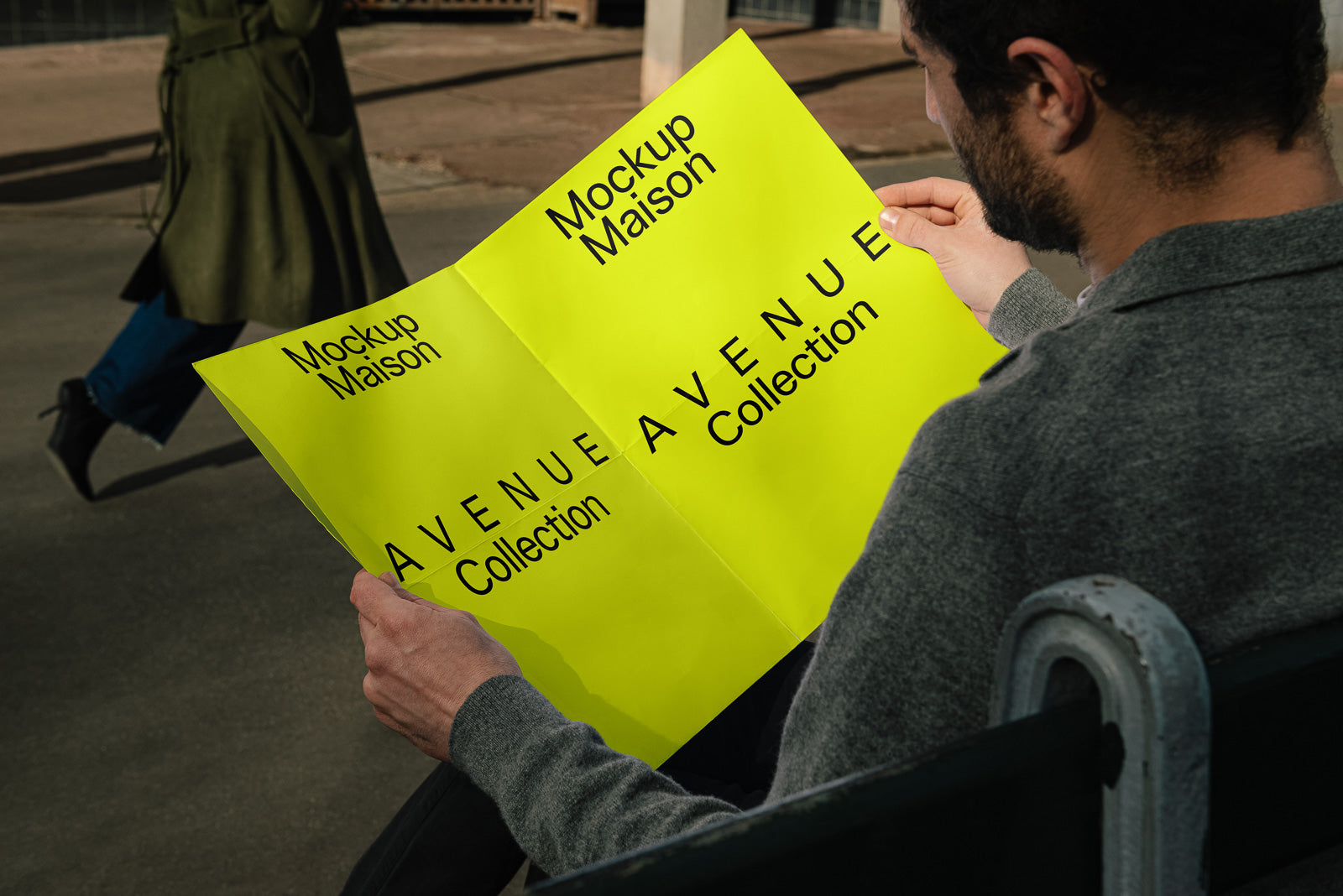 PSD mockup of a person holding a bright yellow poster featuring the text "Mockup Maison" and "AVENUE Collection."
