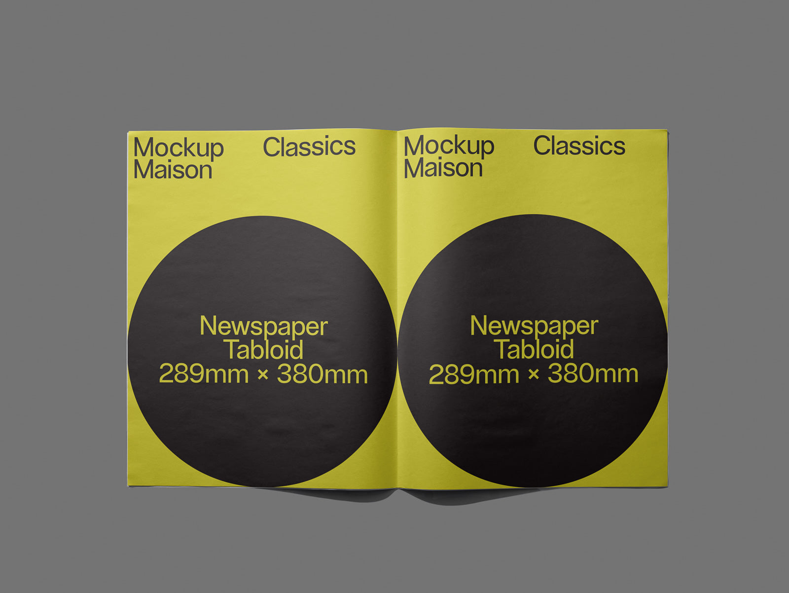 PSD mockup of a newspaper tabloid layout, open on a gray background, featuring two pages with bold text and circular black elements.