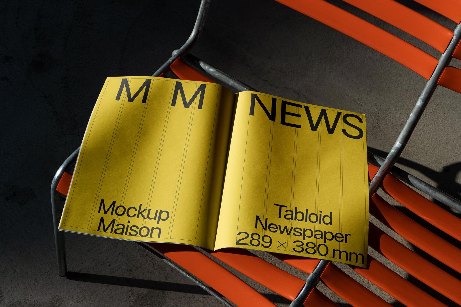 PSD mockup of a tabloid newspaper with a yellow cover, labeled "Mockup Maison" and "Tabloid Newspaper 289 x 380 mm," placed on an orange chair.