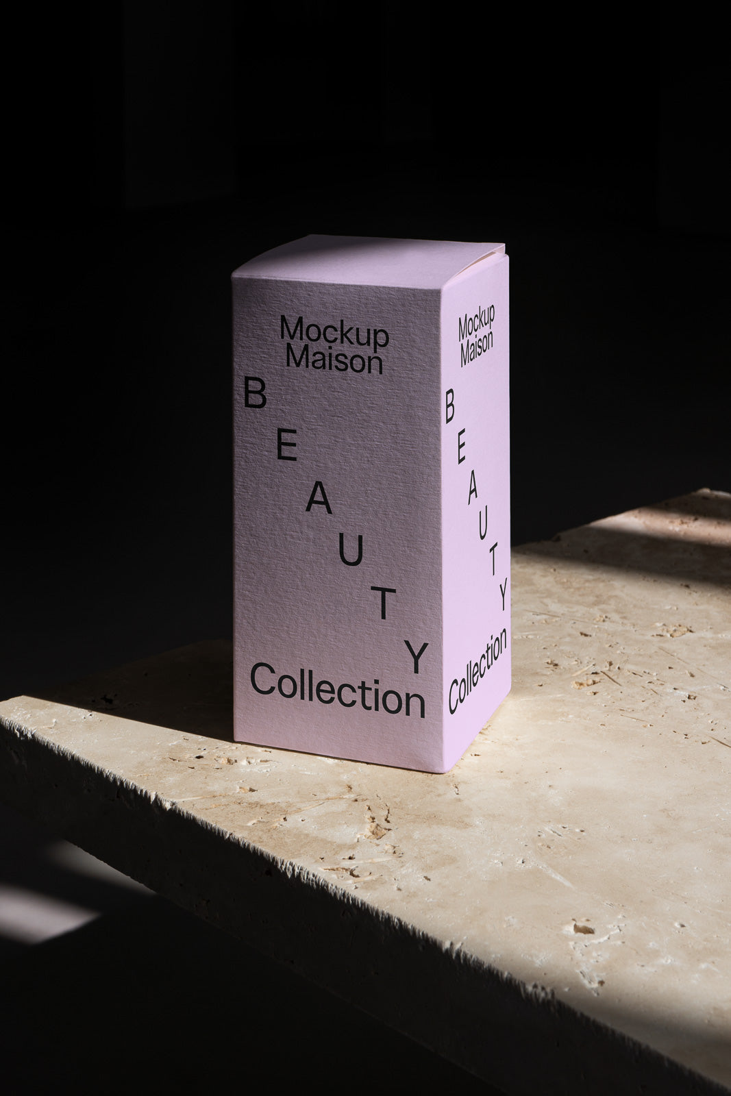 PSD mockup of a pink rectangular box labeled "Mockup Maison Beauty Collection" standing on a textured stone surface with dramatic lighting.