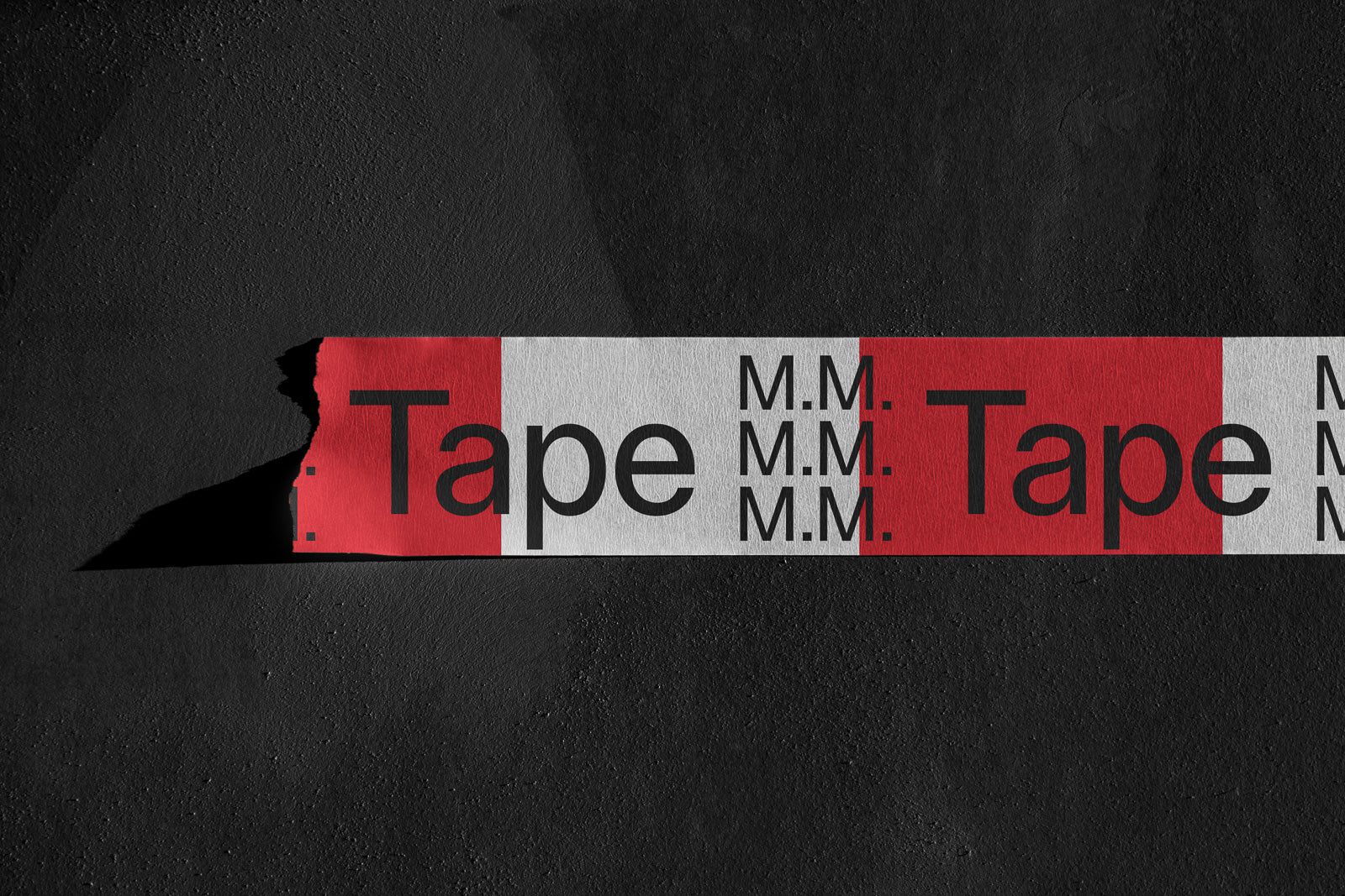 PSD mockup of a red and white tape with the word "Tape" and initials "M.M." on a textured dark surface.