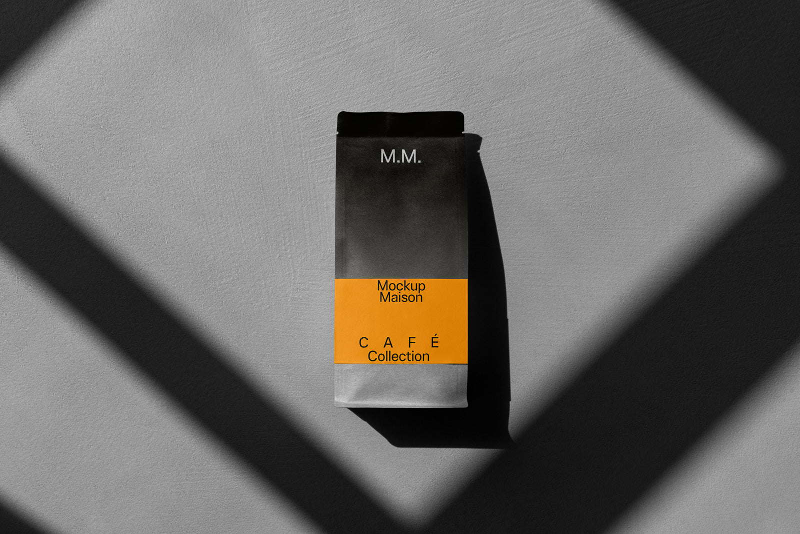 PSD mockup of a coffee bag design featuring a two-tone color scheme with black and orange sections, labeled "Mockup Maison" and "Café Collection."