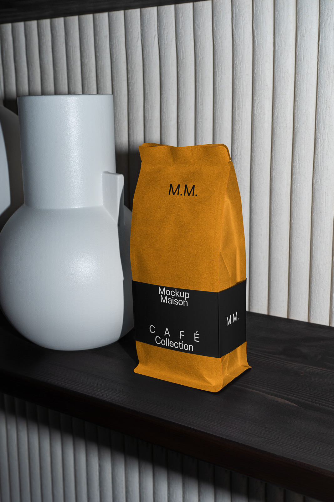PSD mockup of a brown paper coffee bag labeled "Mockup Maison" and "Café Collection" placed on a dark wooden shelf beside a white ceramic vase.
