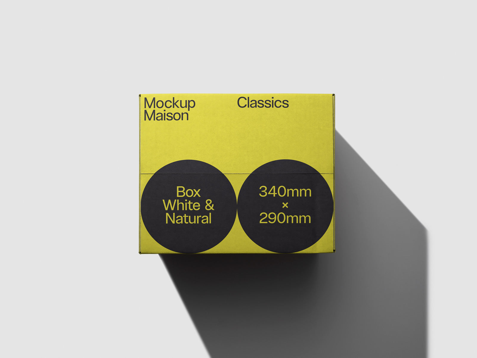 PSD mockup of a yellow cardboard box labeled "Box White & Natural" with dimensions 340mm x 290mm, casting a shadow on a light background.
