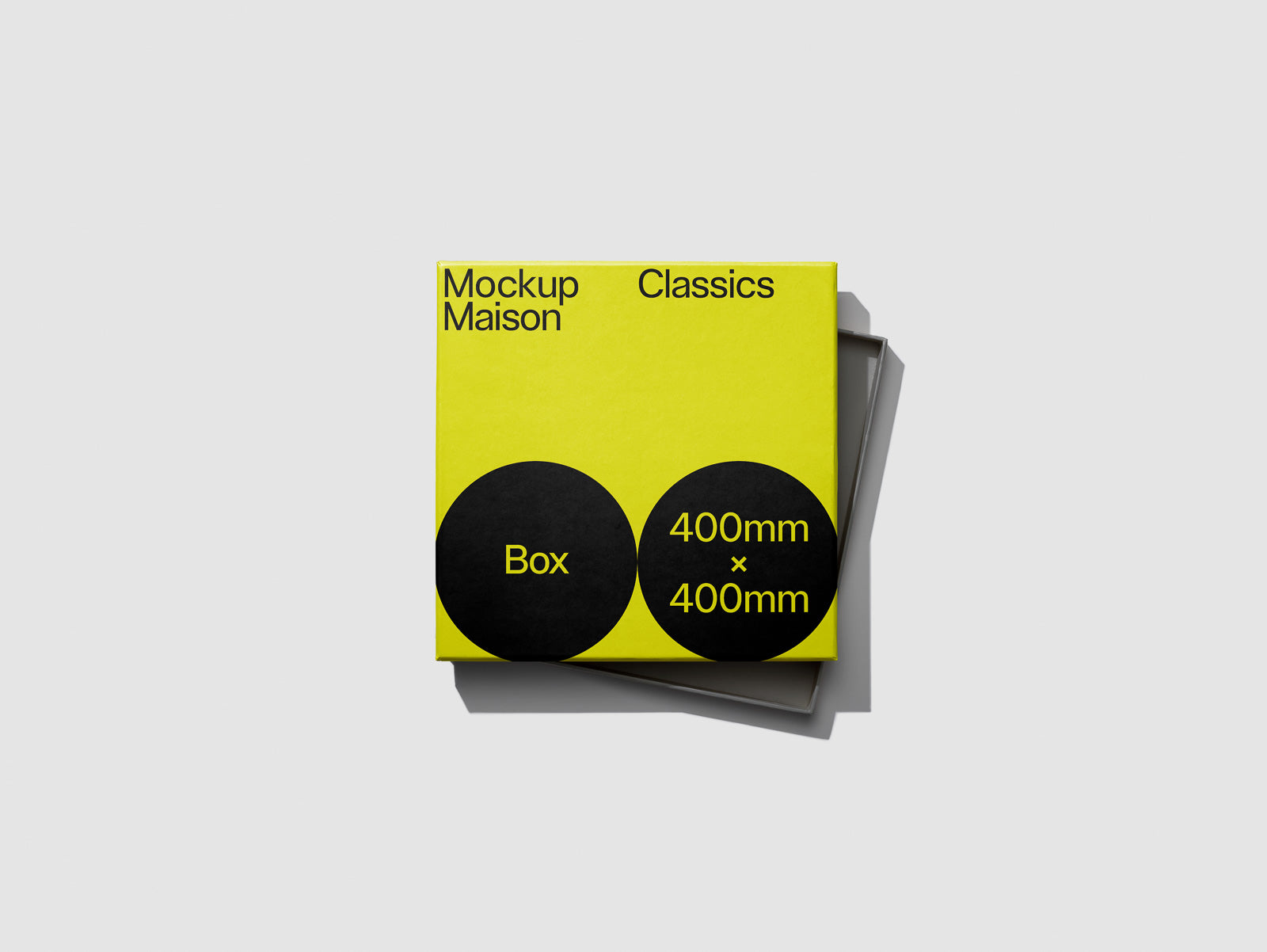 PSD mockup of a yellow box with "Mockup Maison Classics" text and black circles labeled "Box" and "400mm x 400mm," with a slight shadow on a gray background.