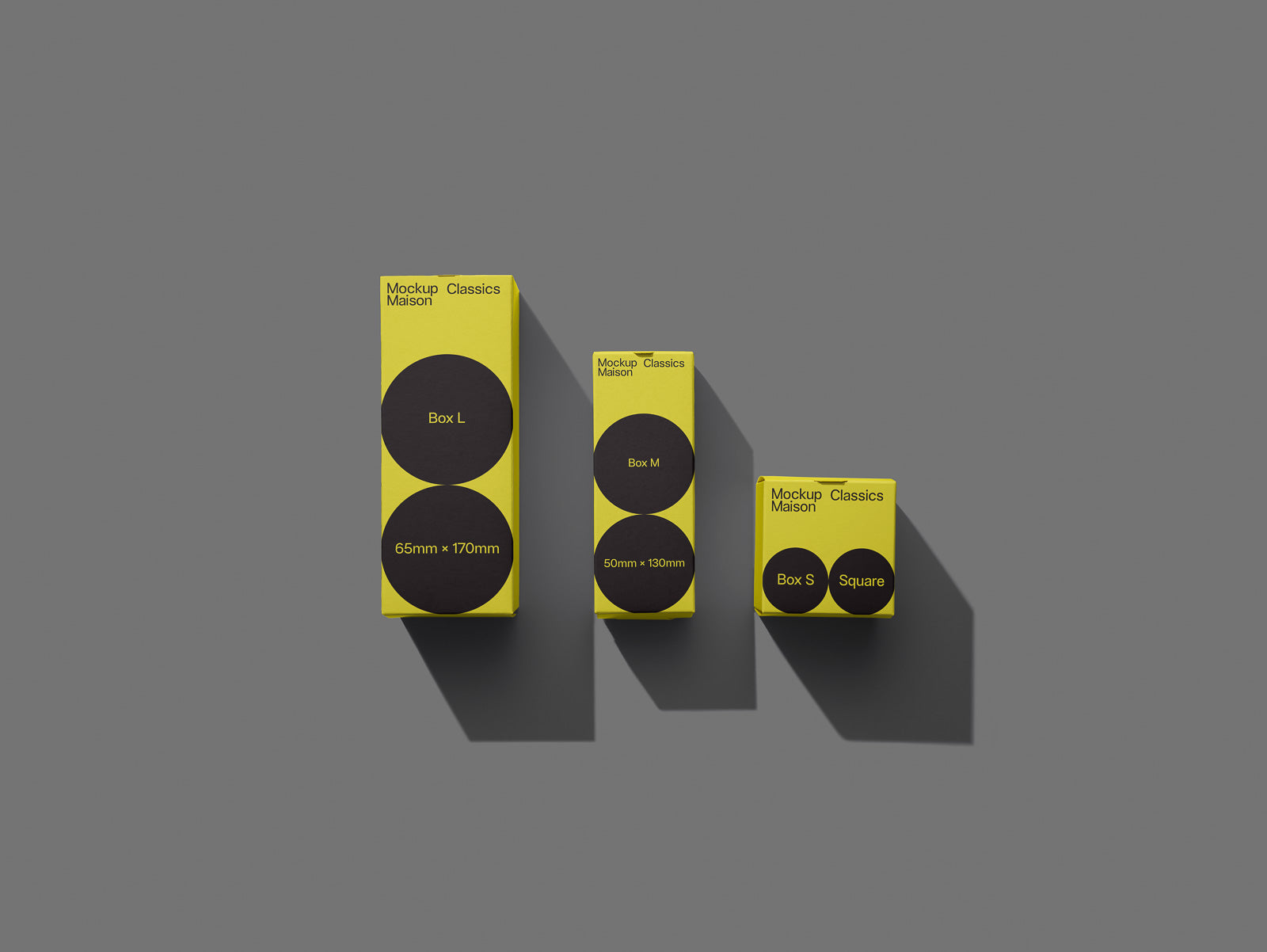 PSD mockup of three yellow packaging boxes with black circles, labeled Box L (65mm x 170mm), Box M (50mm x 130mm), and Box S Square, on a gray background.
